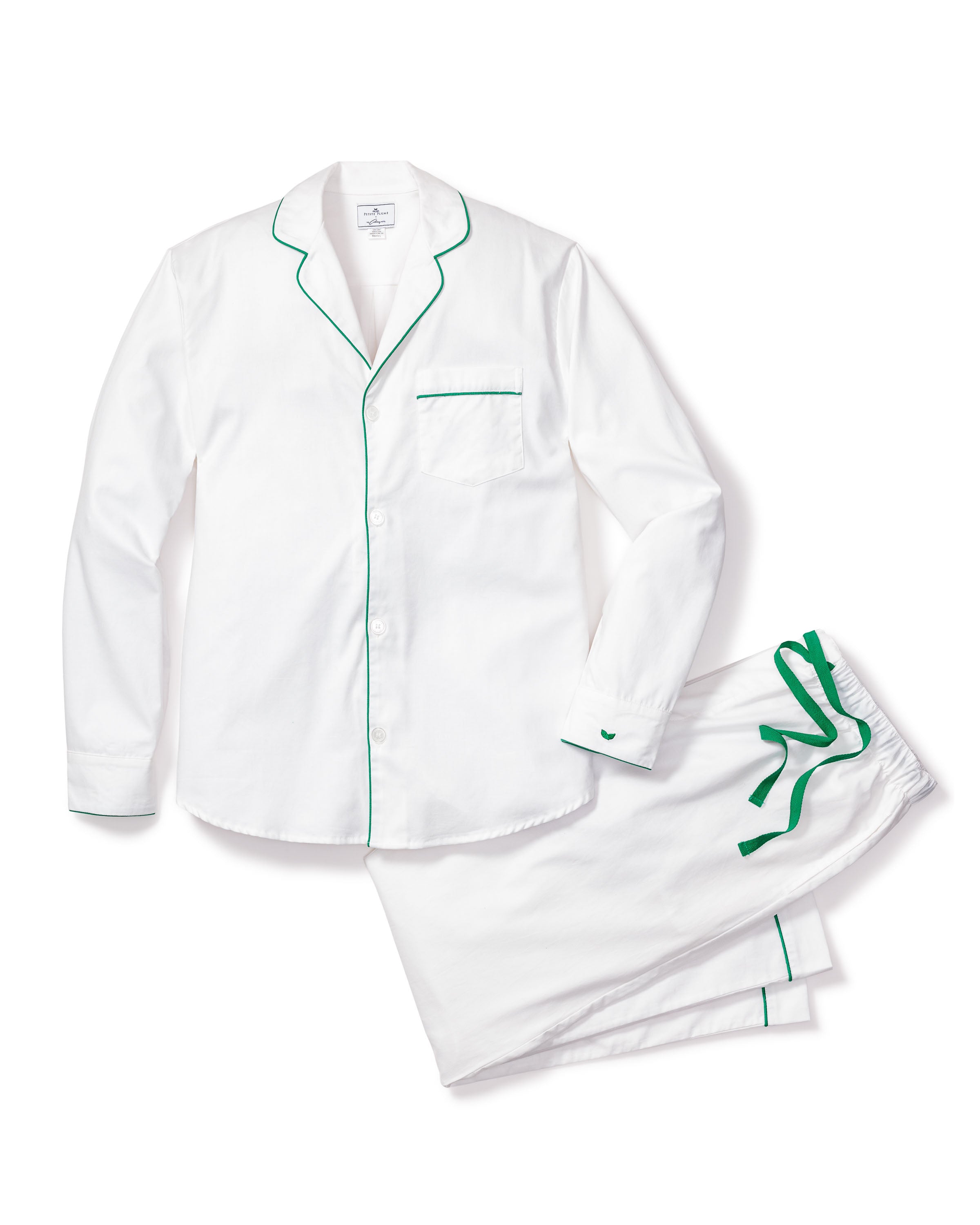 The Mens Twill Pajama Set by Petite Plume in white with green piping, crafted from high-quality cotton, includes a long-sleeved button-up top with chest pocket and matching pants featuring an elastic waistband and drawstring, elegantly displayed on a white background.