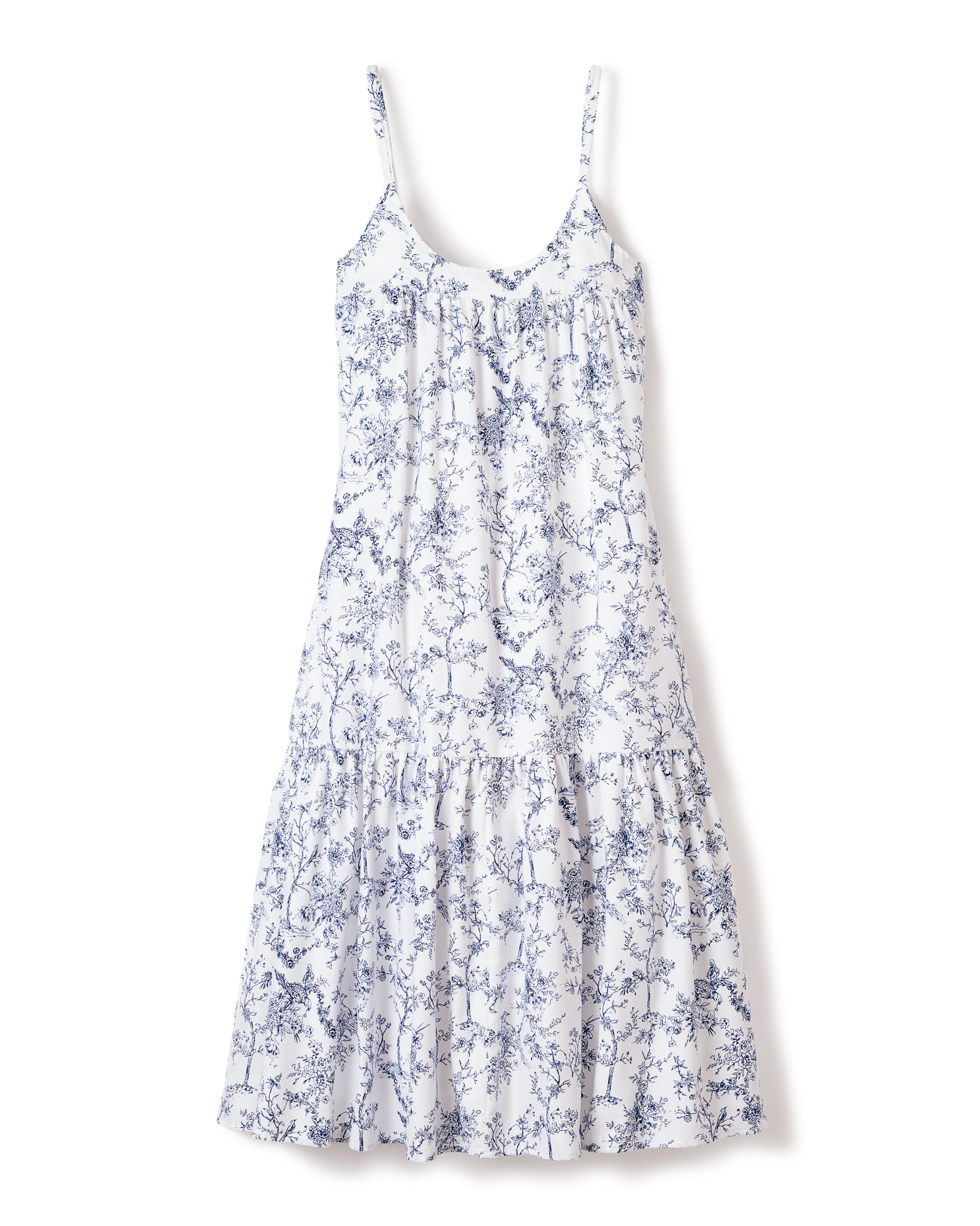 The Womens Twill Chloé Nightgown in Timeless Toile by Petite Plume is a sleeveless white dress with thin straps and a tiered skirt, adorned with a delicate blue floral pattern reminiscent of vintage prints.