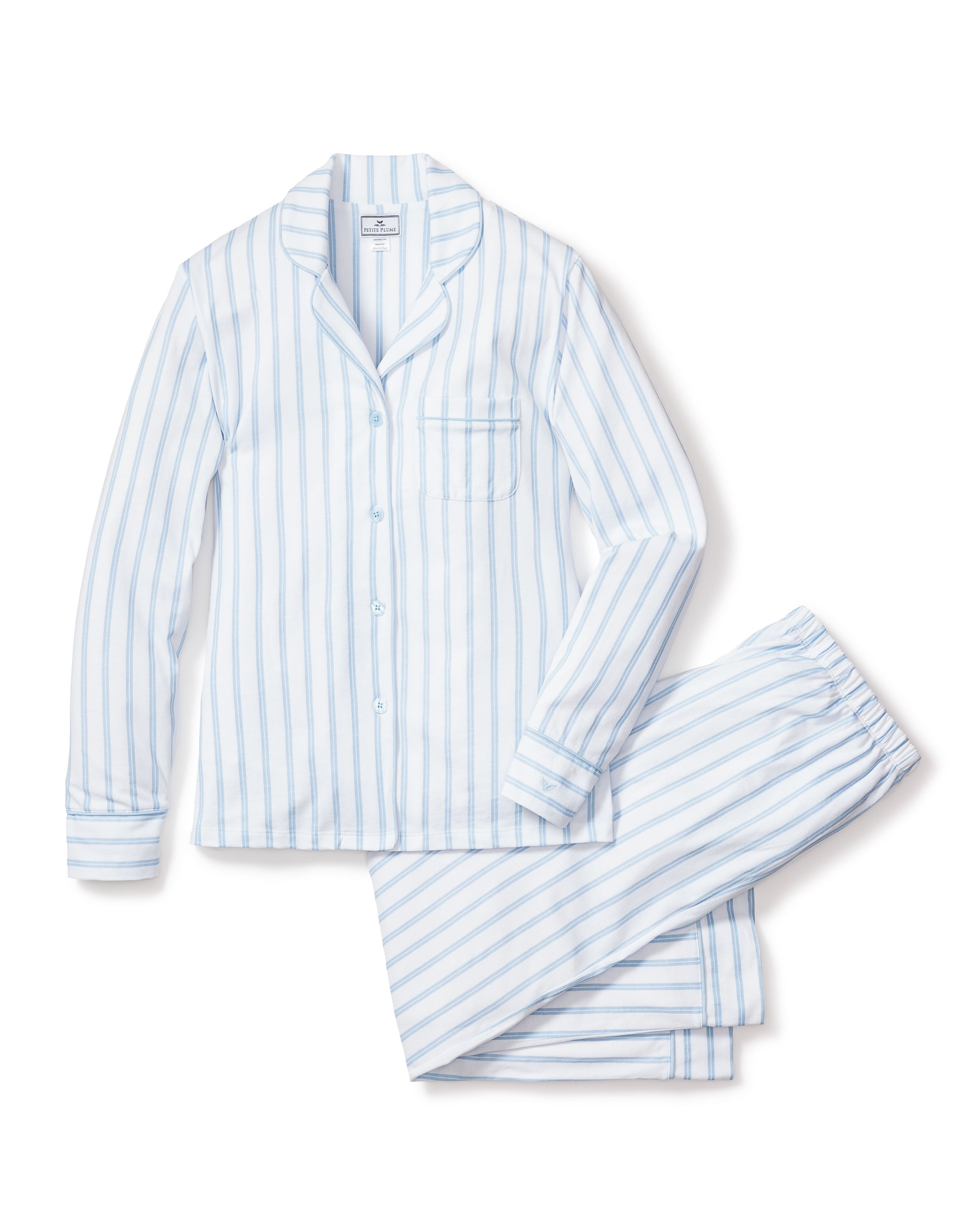 The Womens Pima Pajama Set in Periwinkle Stripe by Petite Plume is a luxurious classic crafted from soft Pima cotton, featuring a long-sleeve button-up shirt with a single chest pocket and matching pants in light blue and white vertical stripes.