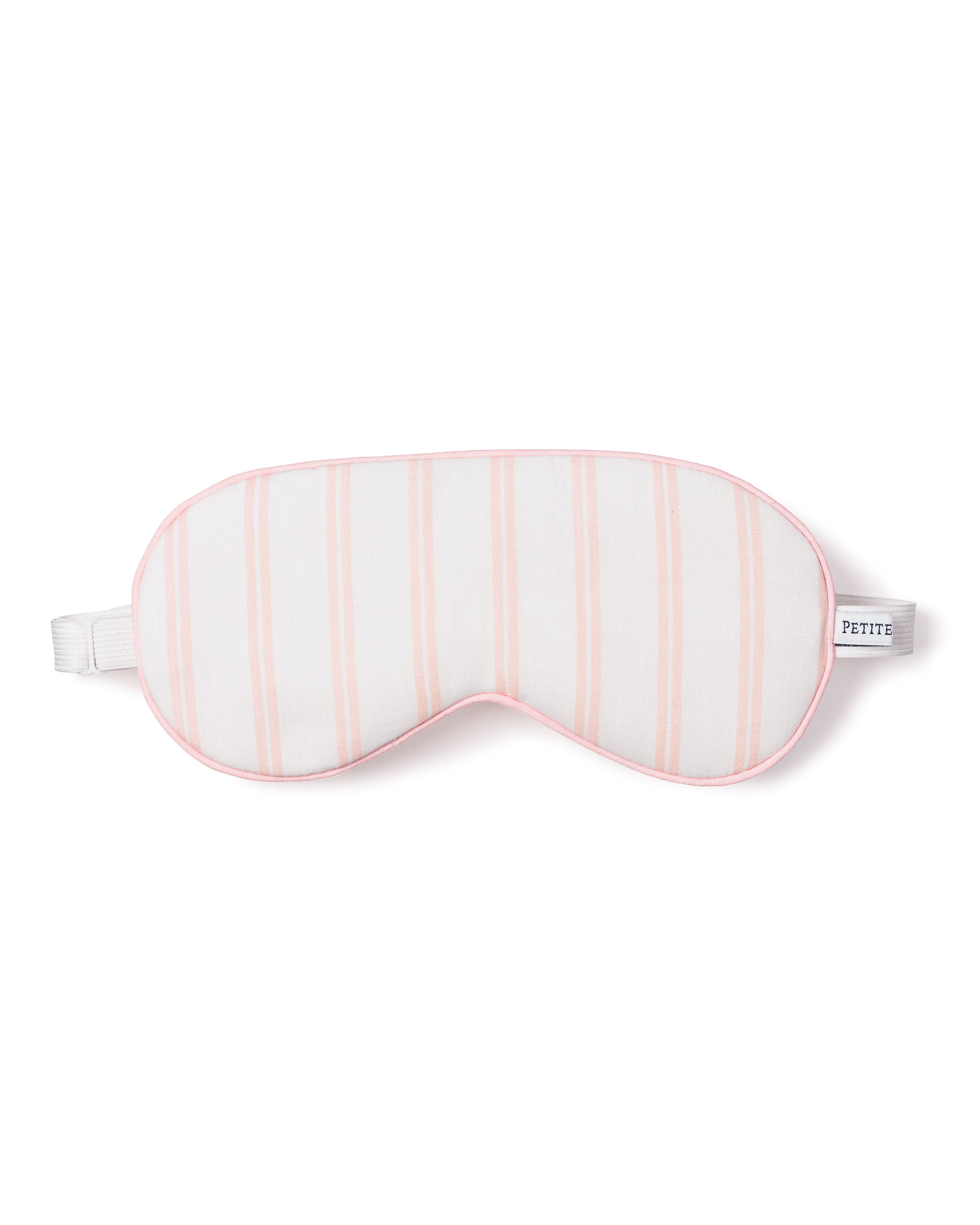 The Kids Twill Sleep Mask by Petite Plume in pink and white stripe exudes luxury. Its soft, padded design with an elastic strap is perfect for matching eye masks. A small tag reads PETITE.