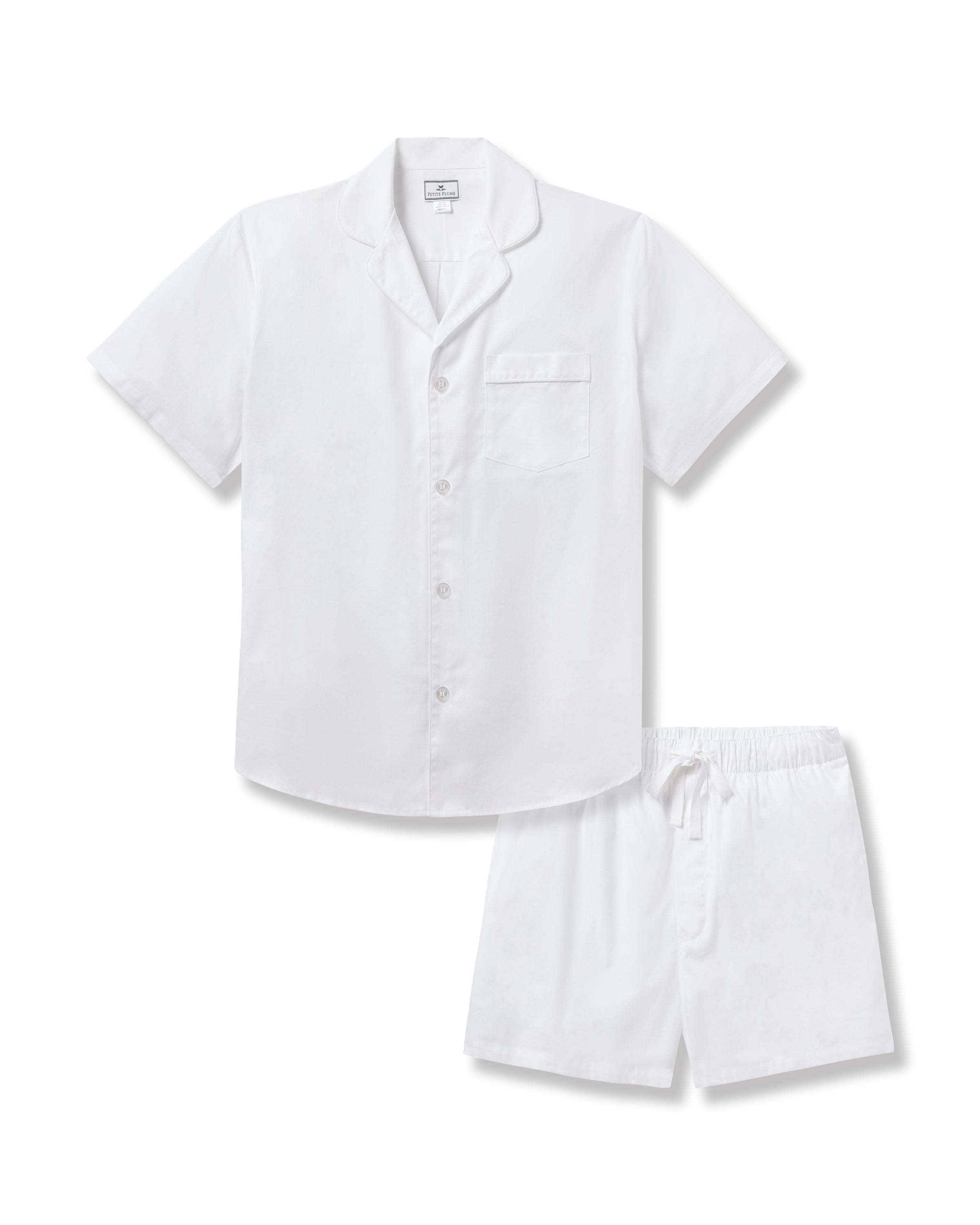 The Mens Twill Pajama Short Set by Petite Plume features a white short-sleeve button-up shirt with a chest pocket and white drawstring shorts, all crafted from yarn-dyed fabric for luxurious softness.