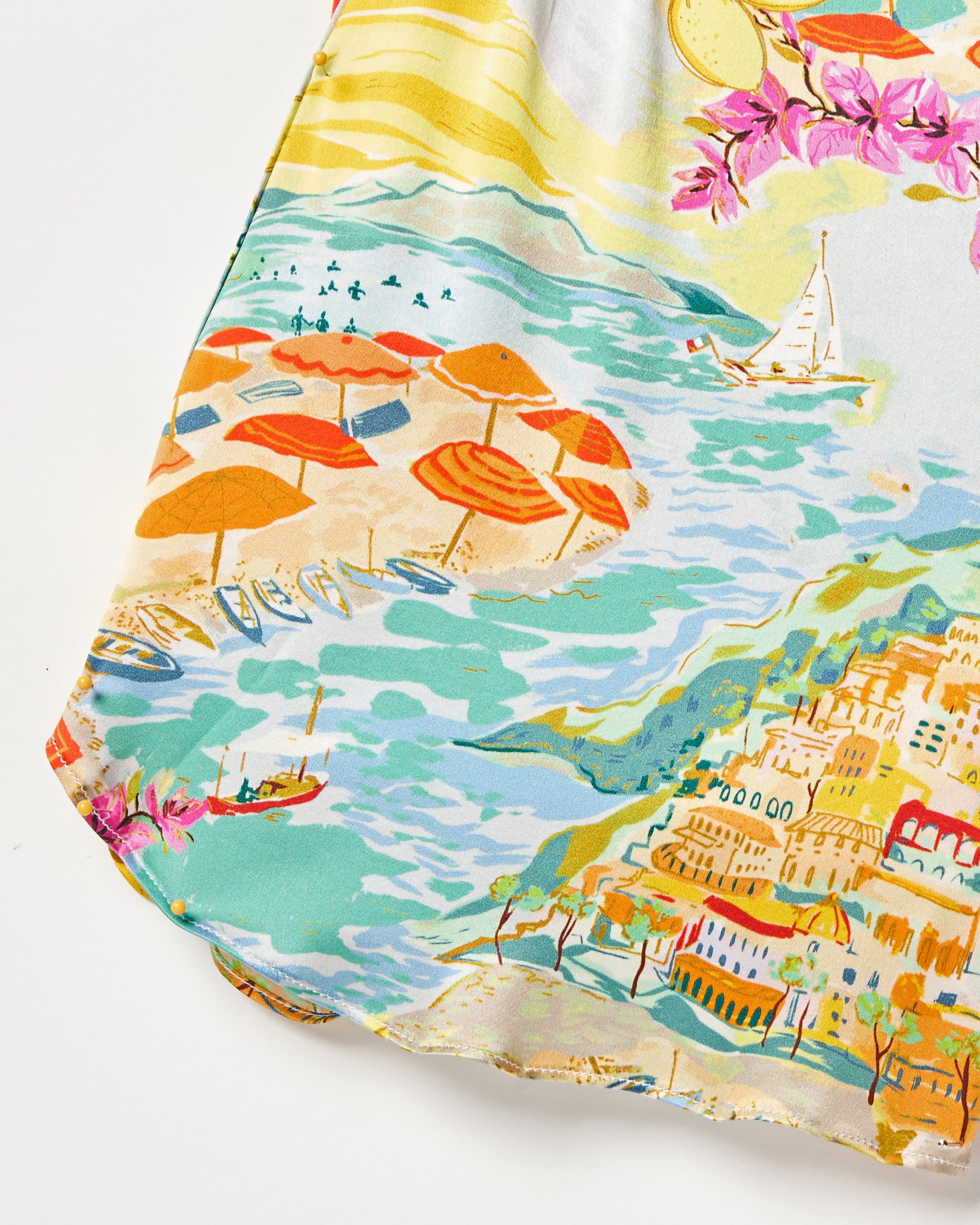 Petite Plumes Womens Silk Cami Short Set in La Dolce Vita features a vibrant coastal scene with orange beach umbrellas, blue sailboats, a hillside town, pink flowers, and a sun—perfect for luxurious sleepwear crafting.