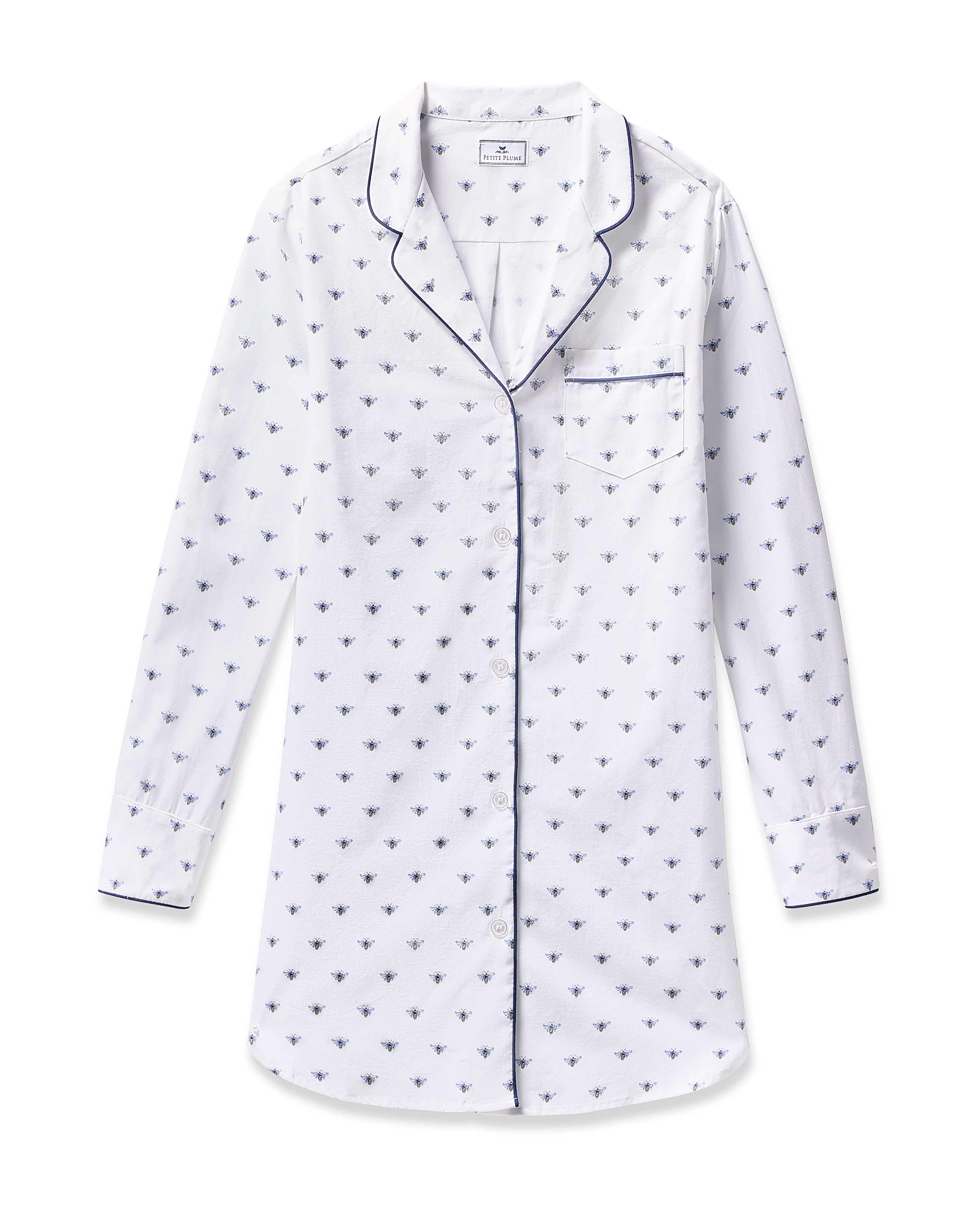 Petite Plumes Womens Twill Nightshirt in Buzzing Bees boasts a white cotton twill long-sleeve top with a blue bee pattern, notched collar, front pocket, and navy piping.