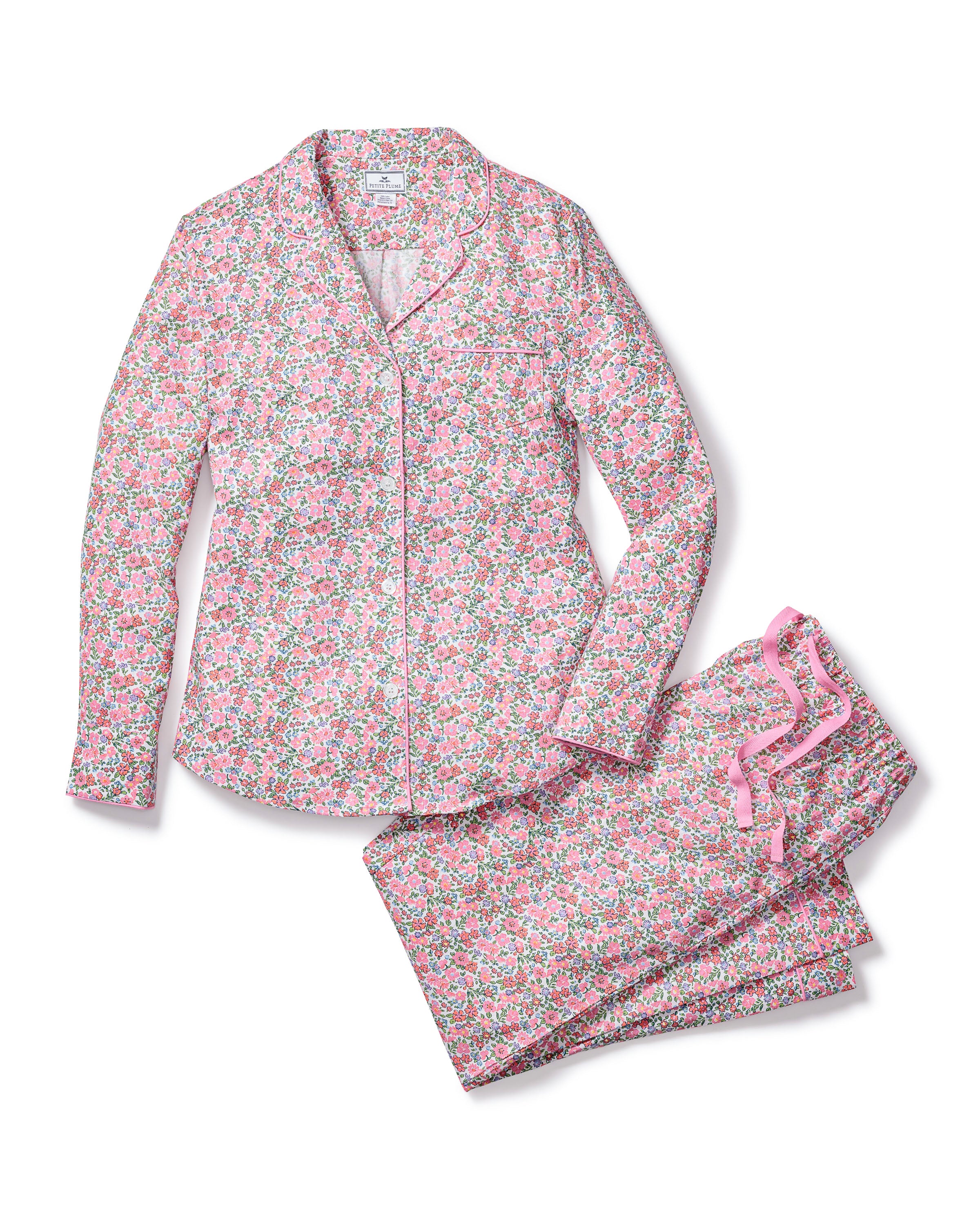 Experience the elegance of Fleurs de Rose with Petite Plumes Womens Twill Pajama Set. This floral-patterned sleepwear features pink, green, and white blossoms on a long-sleeve button-up top and pants tied with a pink ribbon, promising comfort and style for dreamy nights.