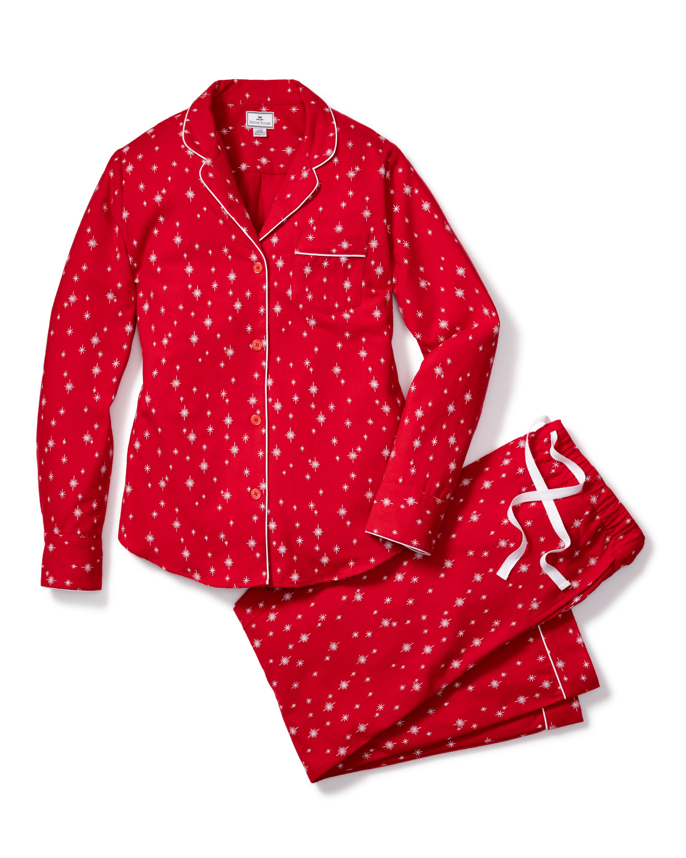 Petite Plumes Womens Flannel Pajama Set in Starry Night features a red cotton long-sleeve button-up top with a breast pocket and white piping, paired with matching pants that have a white star pattern and a drawstring waistband.