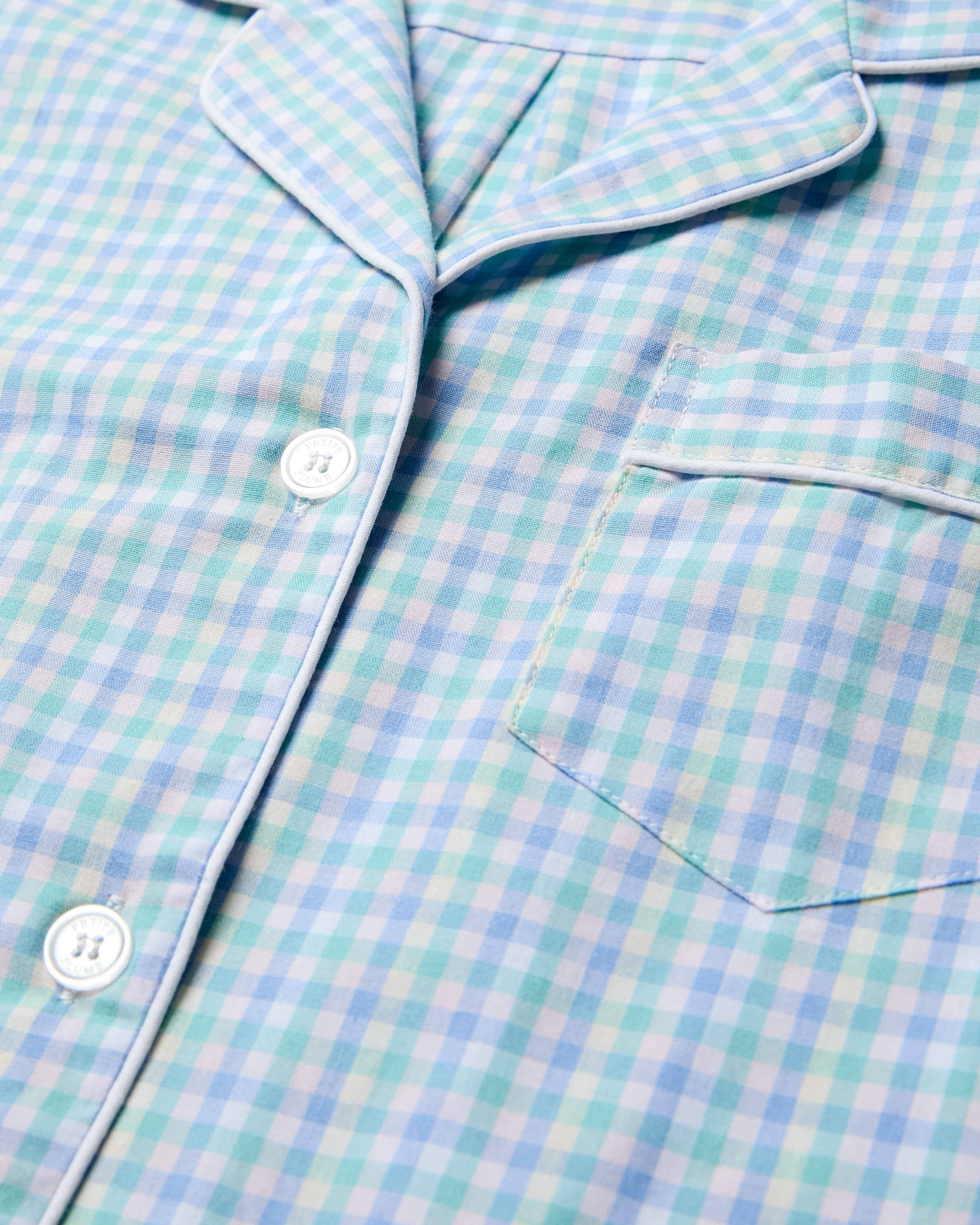 Close-up of Petite Plumes Womens Twill Short Sleeve Short Set in Spring Gingham, showcasing a light blue and white checkered pattern crafted from premium cotton with white buttons, a chest pocket, and a neatly folded collar, offering a smooth luxury sleepwear feel.