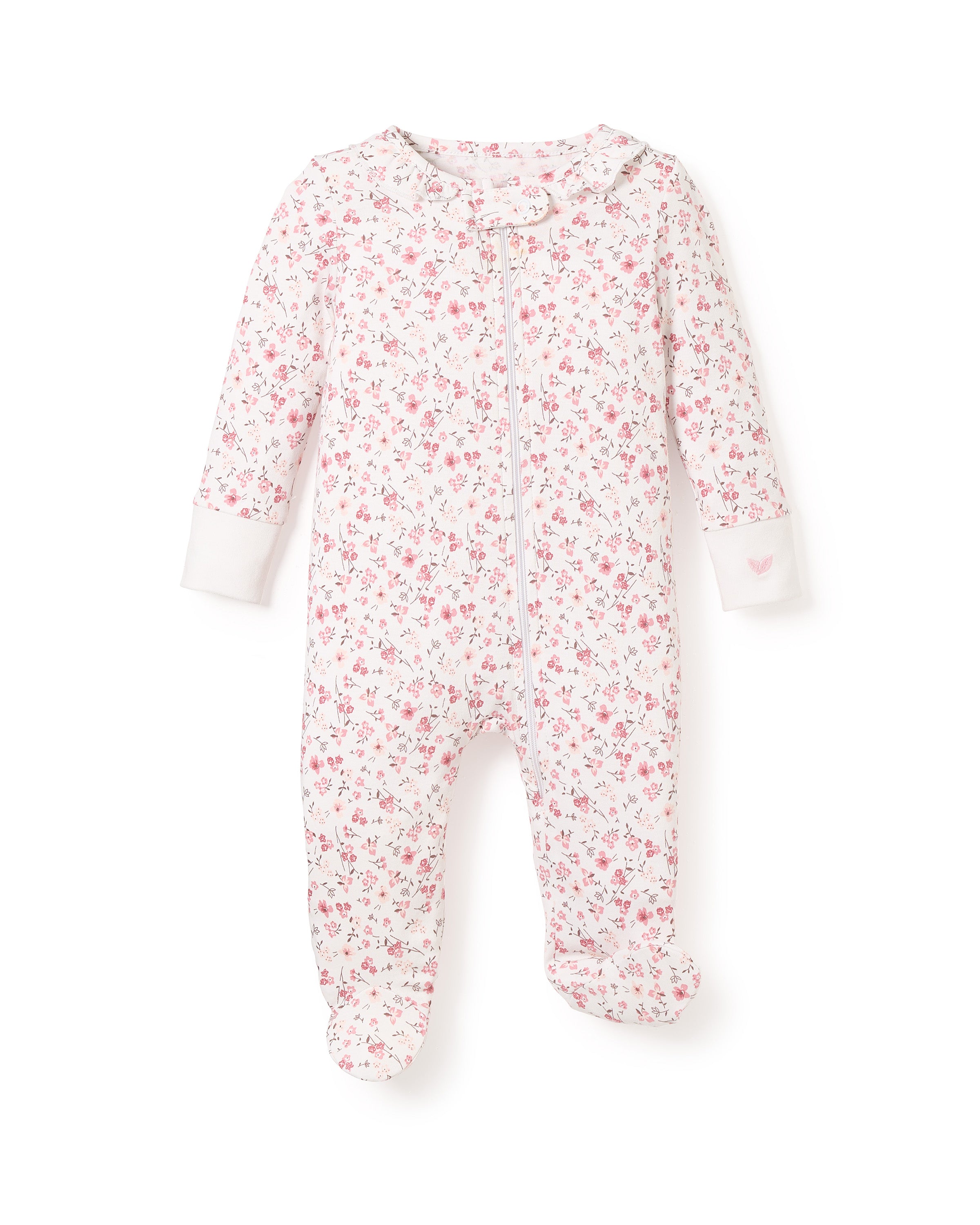 The Babys Pima Ruffle Collar Romper in Dorset Floral by Petite Plume is ultra-breathable with a pink floral pattern on white Pima cotton. It features long sleeves, footed bottoms, a front zipper, and cuffs with small pink heart details, offering luxurious comfort for your little one.