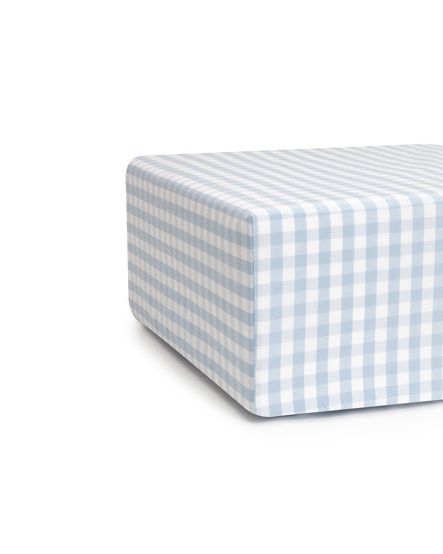 The Luxe Premium Light Blue Gingham Crib Sheet by Petite Plume features an ultra-soft cotton percale fabric with a blue and white checkered pattern, neatly wrapped around the edges for a clean, breathable minimalist look against a plain white background.