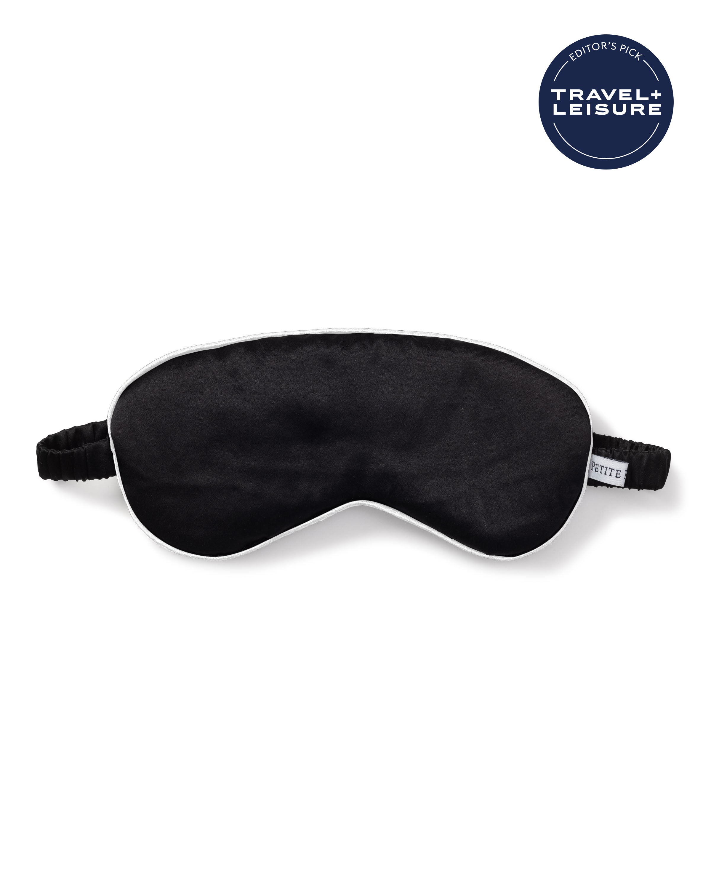 The Adults Silk Sleep Mask in Black by Petite Plume, made from premium silk with a white border and adjustable strap, is showcased on a white background. The Travel + Leisure Editors Pick logo in the top right ensures delightful slumber on every trip.