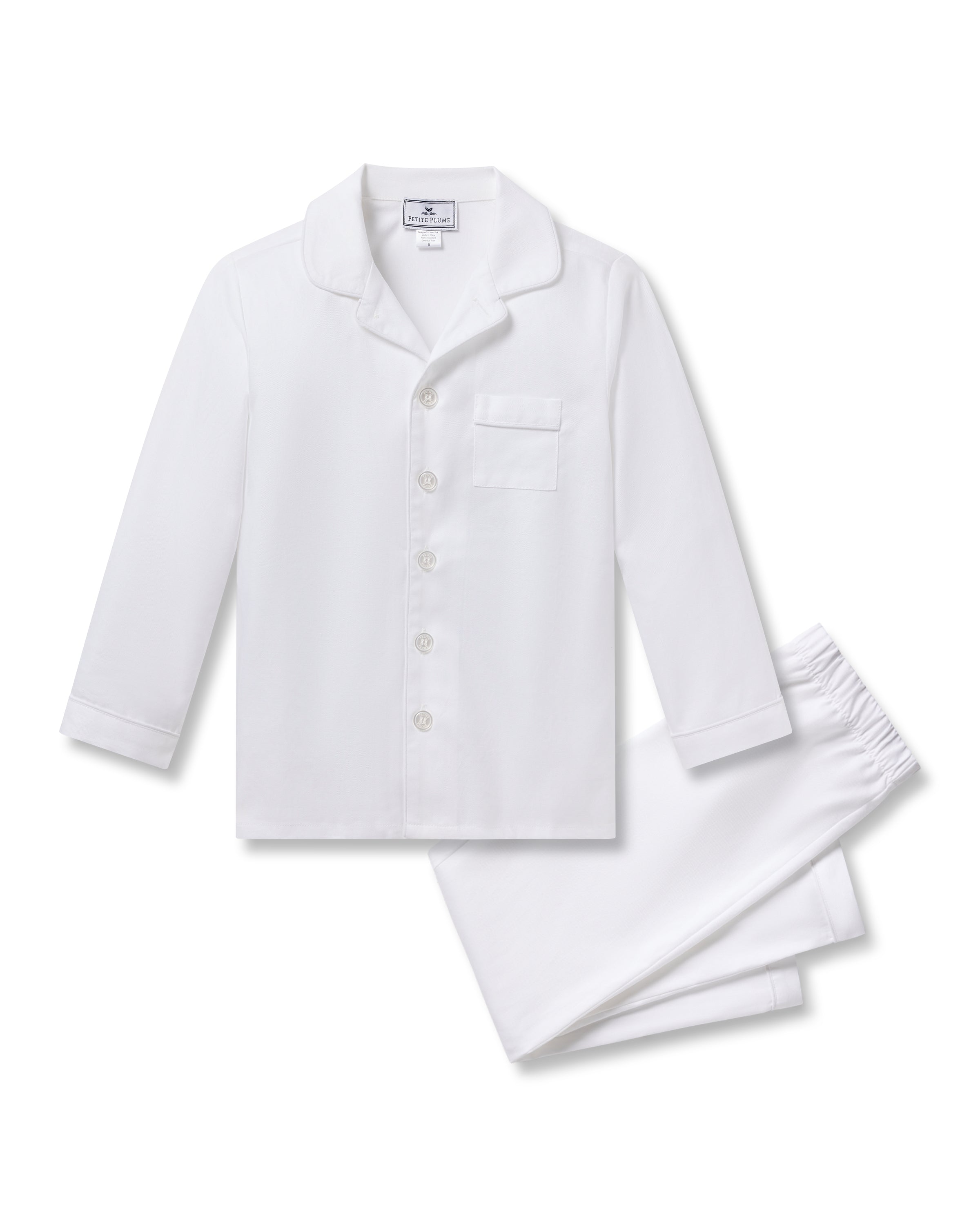 Enjoy a restful nights sleep in the Kids Twill Pajama Set from Petite Plume, featuring a white button-up top with front pocket and matching pants, complemented by elegant white piping.