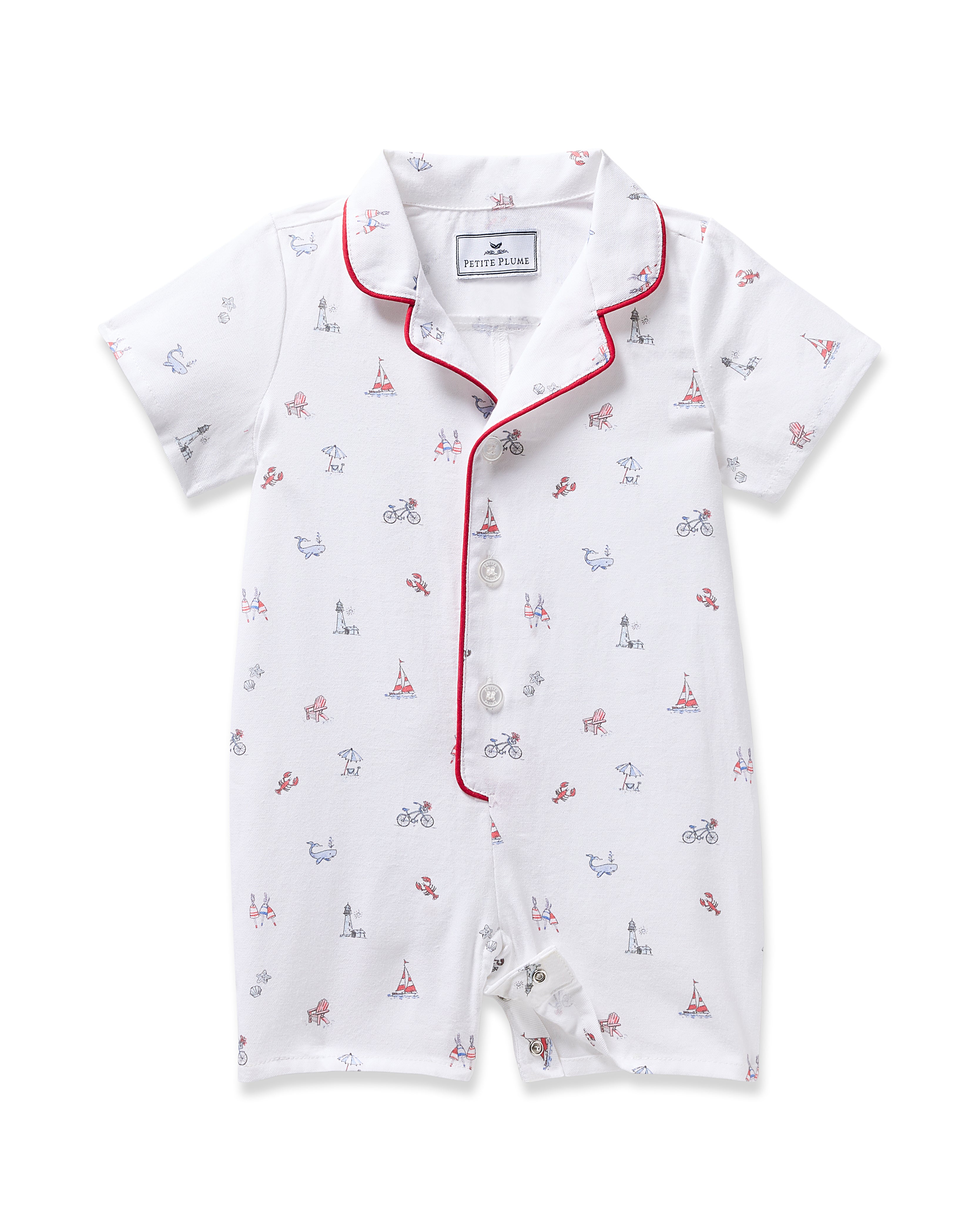 Petite Plumes Babys Twill Summer Romper in Coastal Charms is a white short-sleeve outfit adorned with red and blue Eiffel Towers, bicycles, and cityscapes. Made from brushed twill fabric, it features red piping on the collar and front with a button closure.