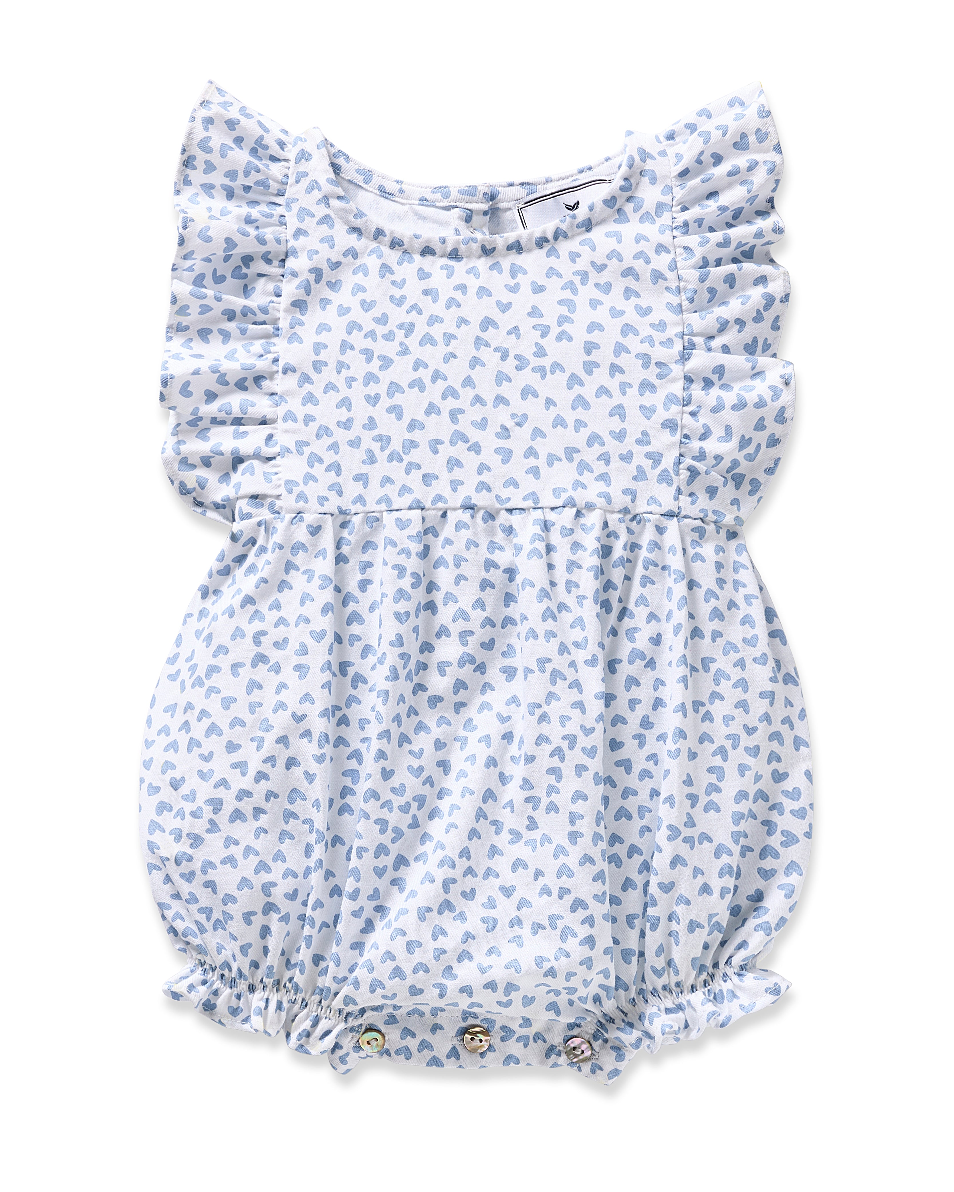 The Babys Twill Ruffled Romper in Bluehearts by Petite Plume is a light blue romper featuring a Bluehearts design, ruffled sleeves, elastic around the legs, and small decorative buttons at the bottom. It is crafted from flame-retardant fiber.