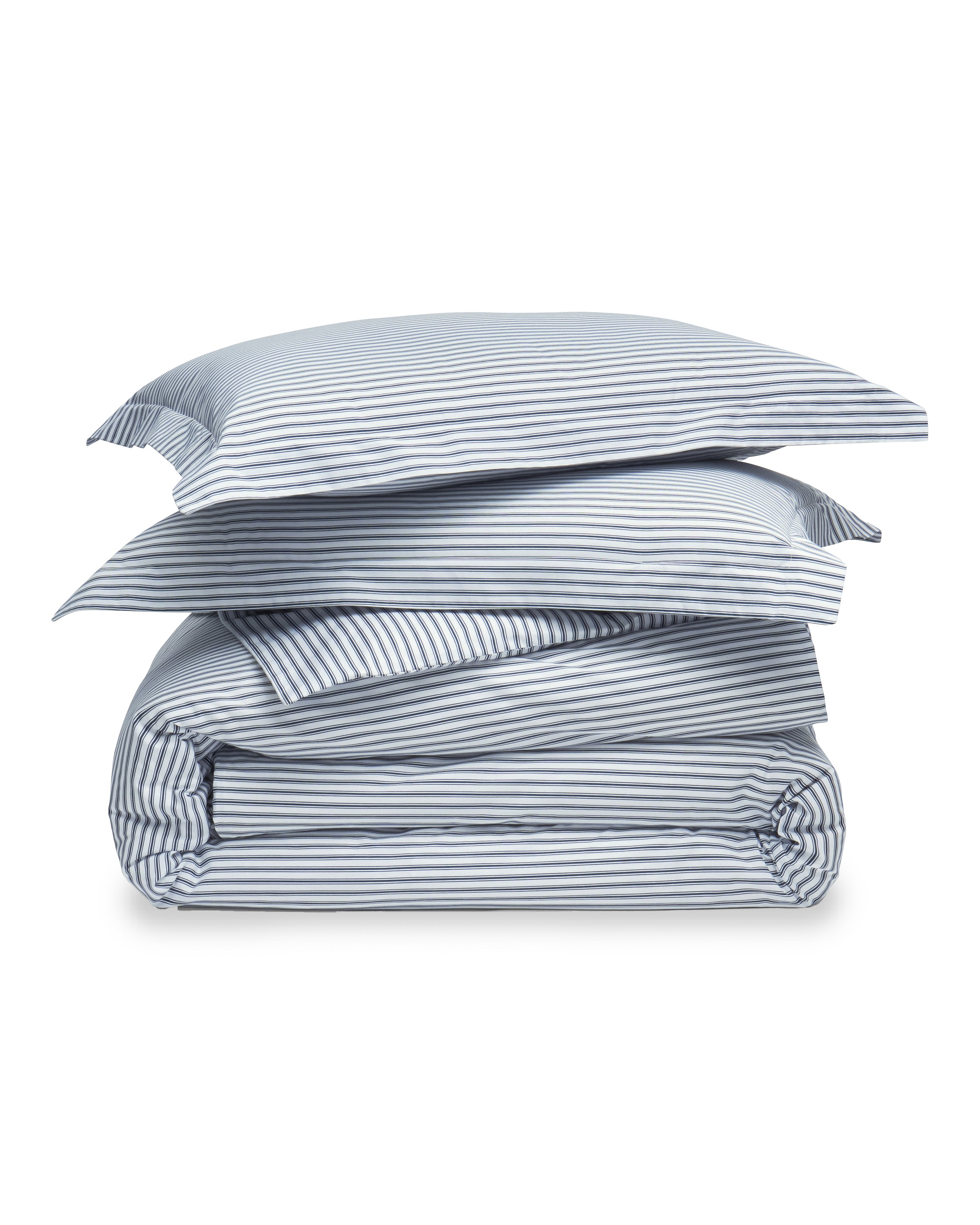 A stack of neatly folded bedding comprises the Luxe Premium Percale Duvet Set in Navy French Ticking by Petite Plume, including a comforter and two pillowcases with a light gray and white striped pattern on a soft cotton weave.