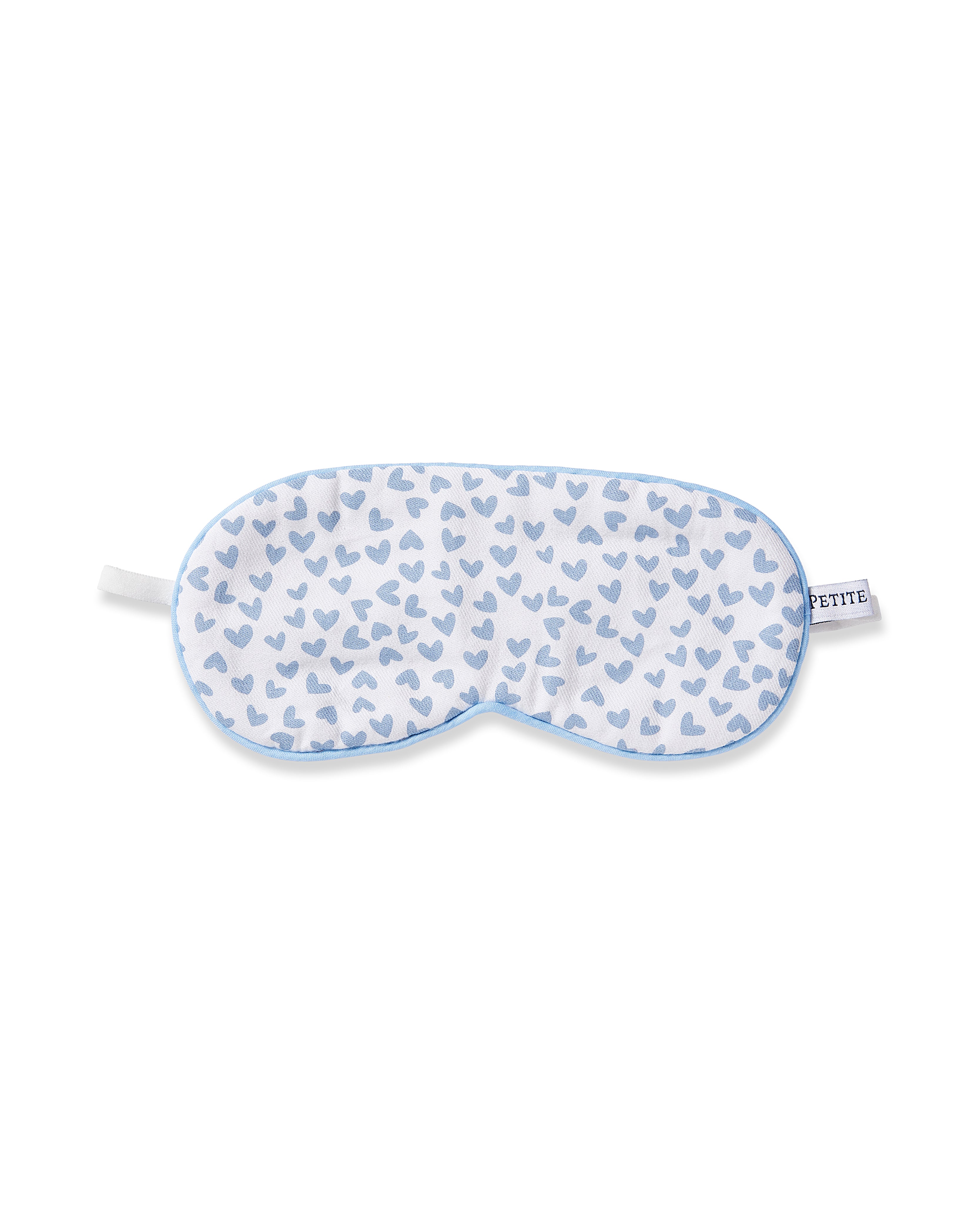 The Kids Twill Sleep Mask in Bluehearts by Petite Plume features a charming design with small blue hearts on white, edged in light blue. A PETITE tag on the right side makes it perfect for monogramming and adds a personal touch to your sleep routine.