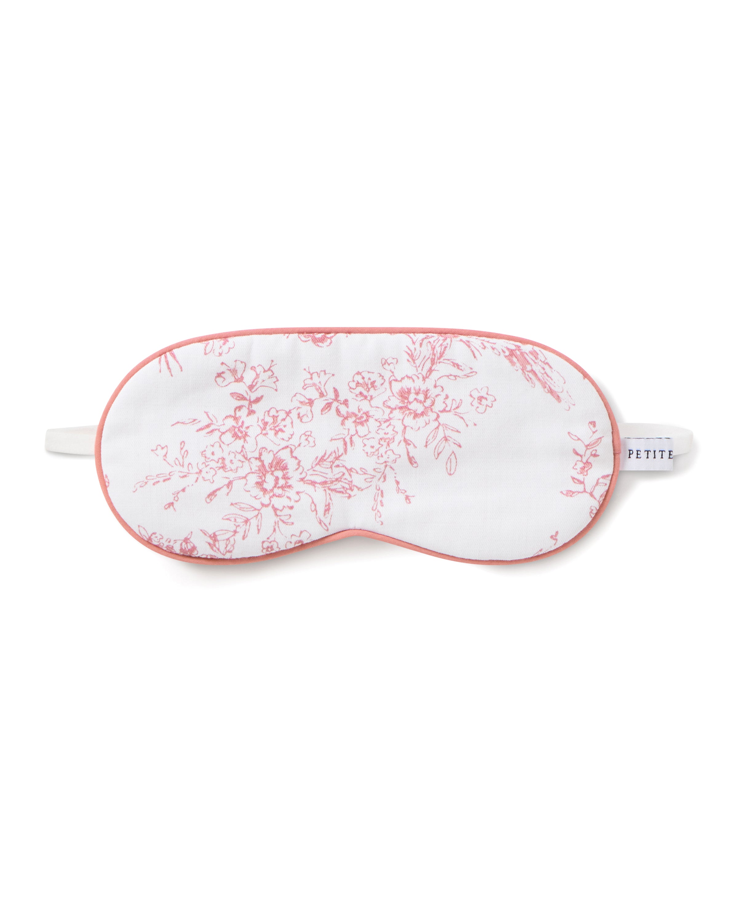 The Kids Twill Sleep Mask in Pink Timeless Toile by Petite Plume features intricate botanical floral patterns with pink edging. A label on the right side reads PETITE, perfectly matching with coordinating eye masks for a cohesive look.