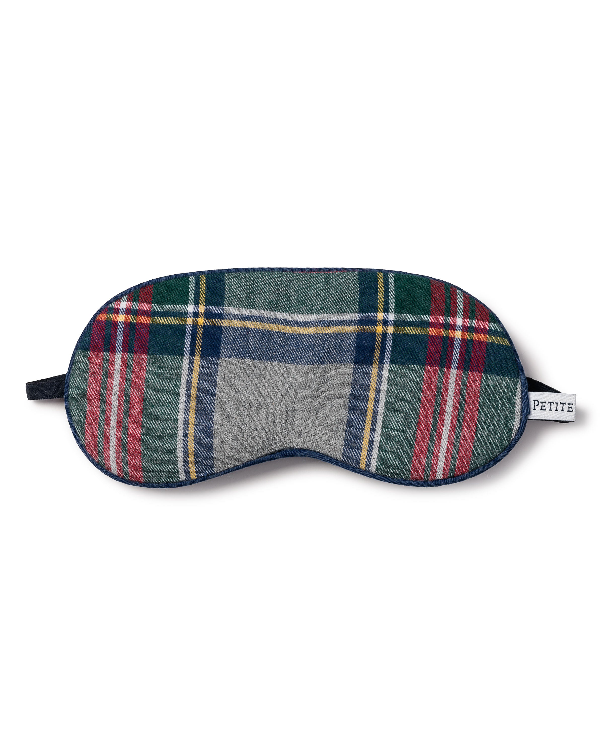 The Kids Brushed Cotton Sleep Mask by Petite Plume features a classic Scottish Westminster Tartan design with red, green, blue, and gray stripes and a side tag that reads PETITE.