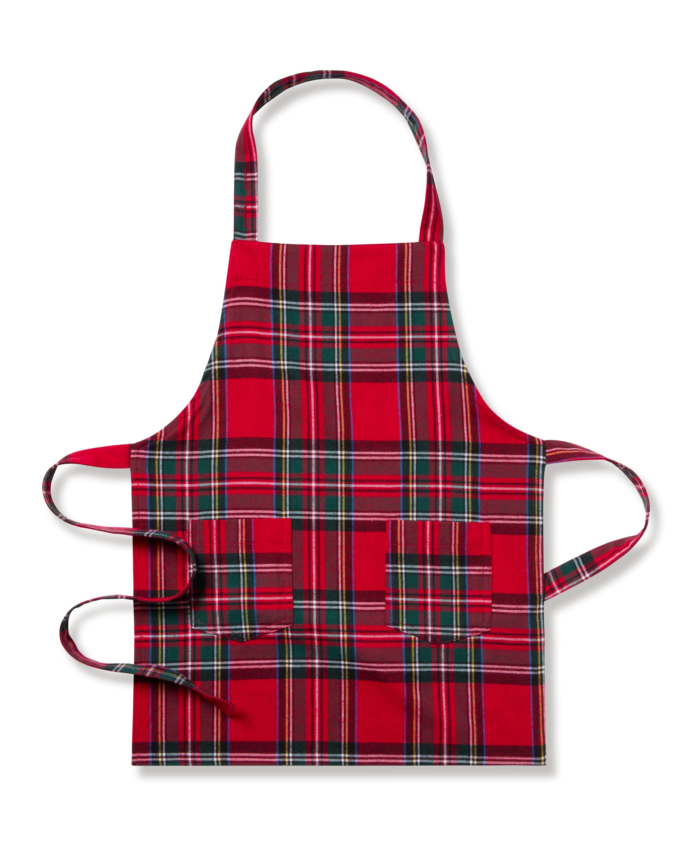 The Kids Apron in Imperial Tartan by Petite Plume is a red, green, and white plaid holiday baking apron featuring an adjustable neck strap, two front pockets, and long waist ties. Ideal for festive cooking sessions, its showcased against a white background.