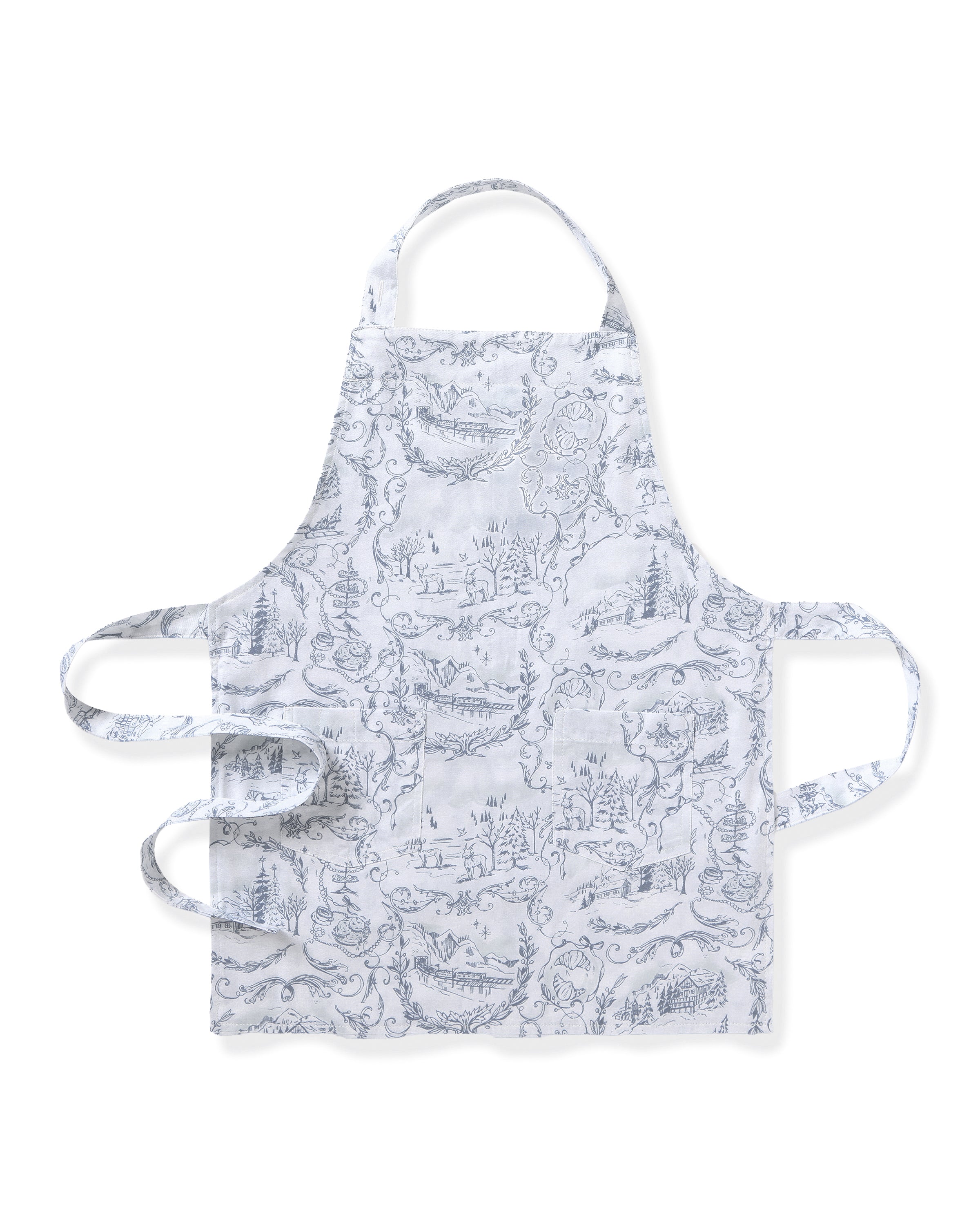 The Maman x Petite Plume Alpine Toile Kids Apron by Petite Plume is a limited-edition white apron adorned with intricate blue line drawings of scenes and landscapes. It features a neck loop and waist ties, creating a charming winter wonderland for holiday baking adventures.