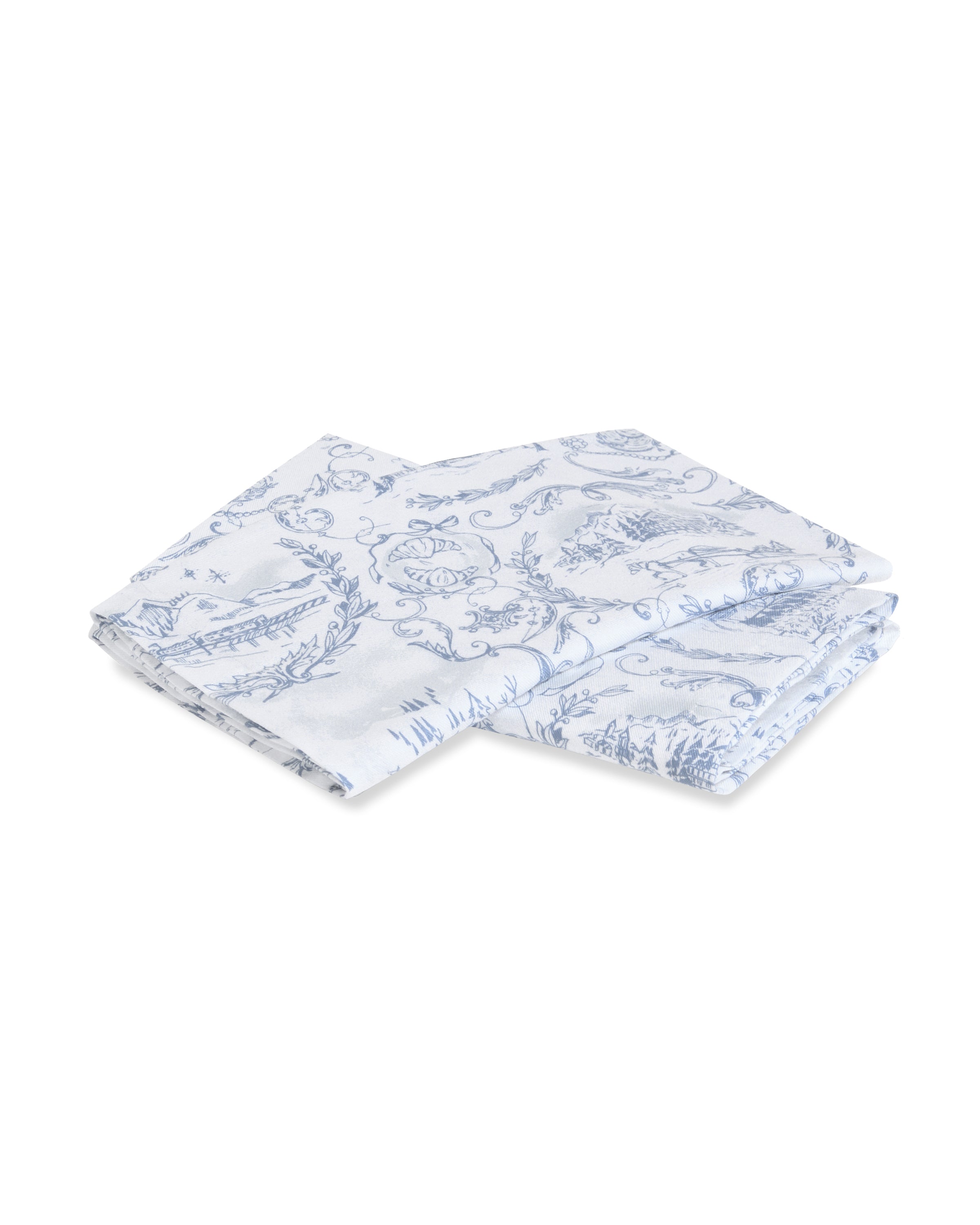 A folded Maman x Petite Plume Alpine Toile Tea Towel, featuring intricate blue floral patterns on white, enhances any festive tablescape with sophistication. From the limited-edition slate blue toile collection by Petite Plume, it stands out against a plain background.