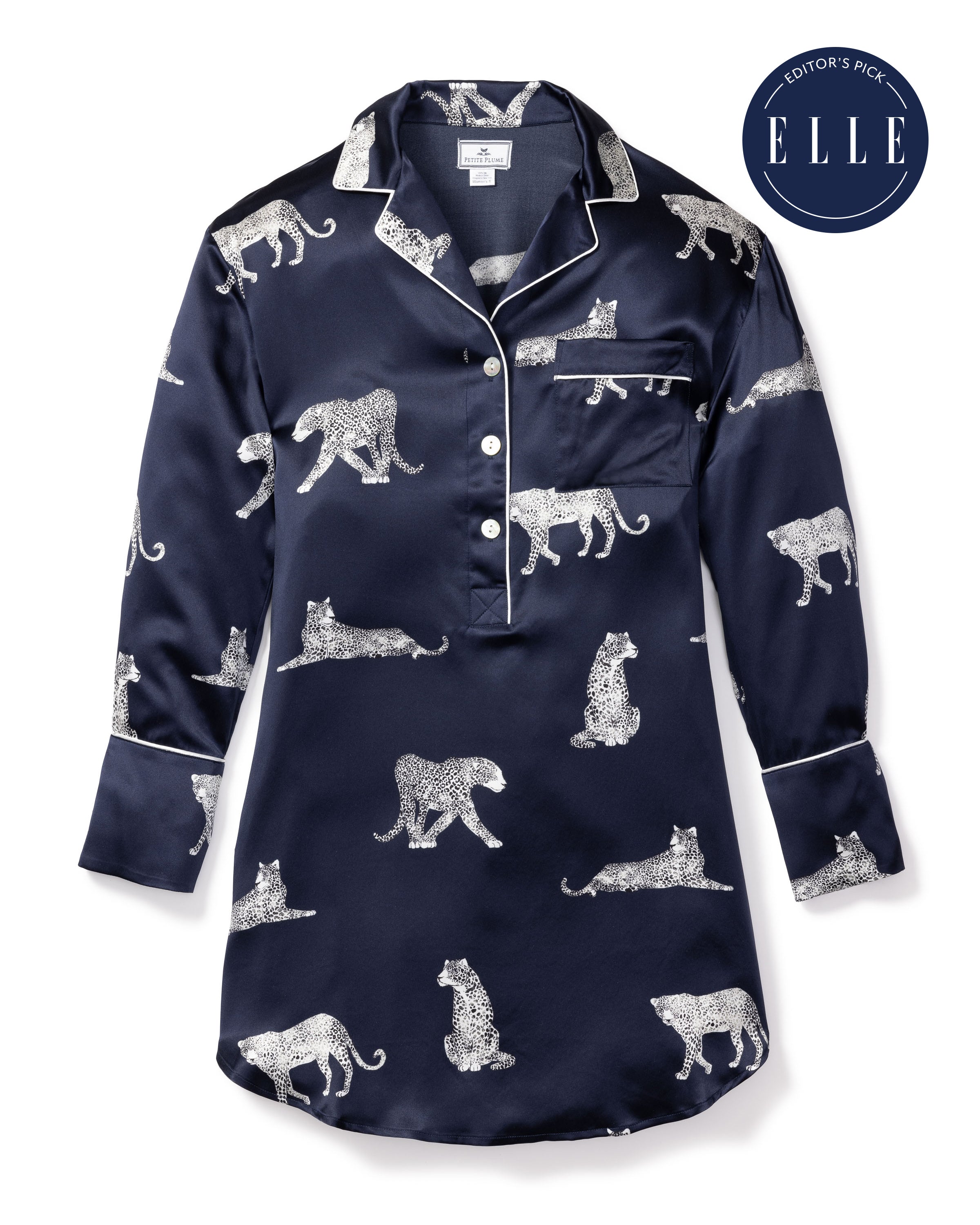 The Womens Silk Nightshirt in Panthère de Nuit by Petite Plume is a luxurious navy blue Mulberry silk piece adorned with white leopard prints, buttons, and a chest pocket. It proudly carries the Editors Pick badge from Elle magazine.