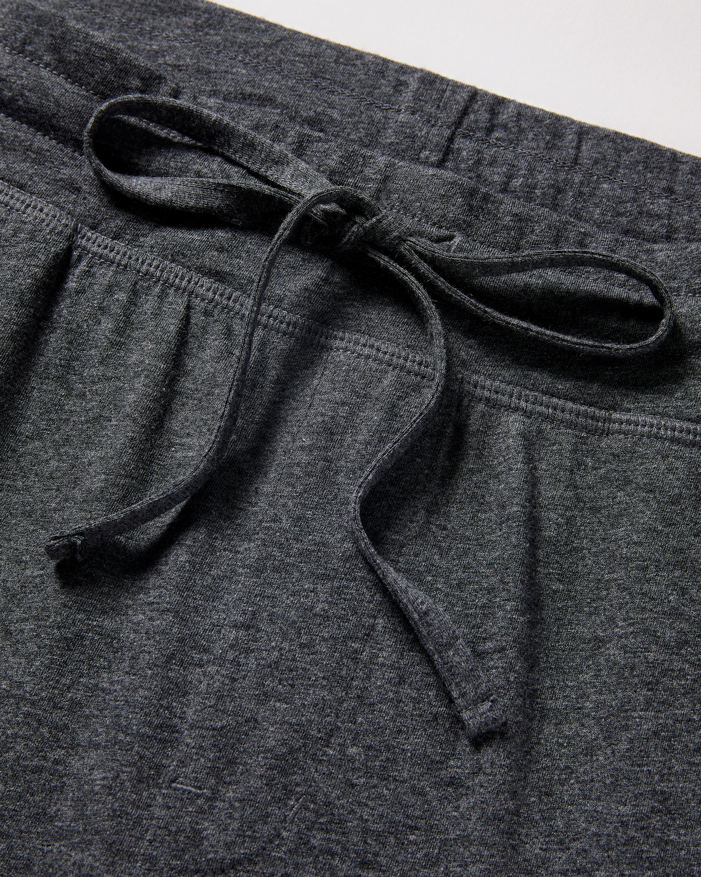 Close-up of Petite Plume Mens 5 Pima Shorts in Dark Grey with a drawstring tied in a bow, showcasing the soft Peruvian Pima cotton fabric gathered at the waistband for a comfortable fit.