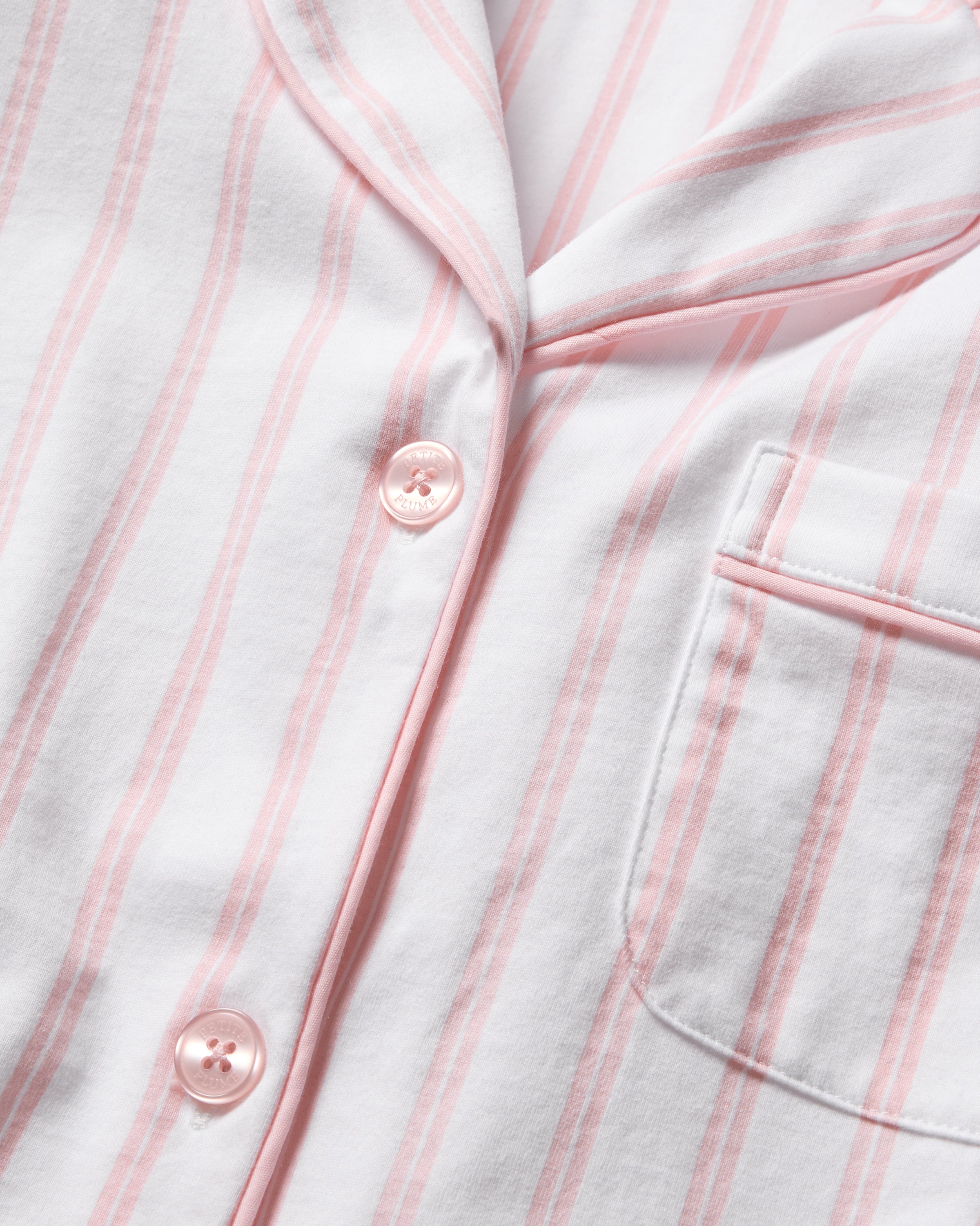 Close-up of Petite Plumes Womens Pima Pajama Set in Pink Stripe, featuring a soft Peruvian Pima cotton pajama shirt with pink stripes, pink buttons, and a chest pocket—ideal for adding luxury to your bedtime ritual.