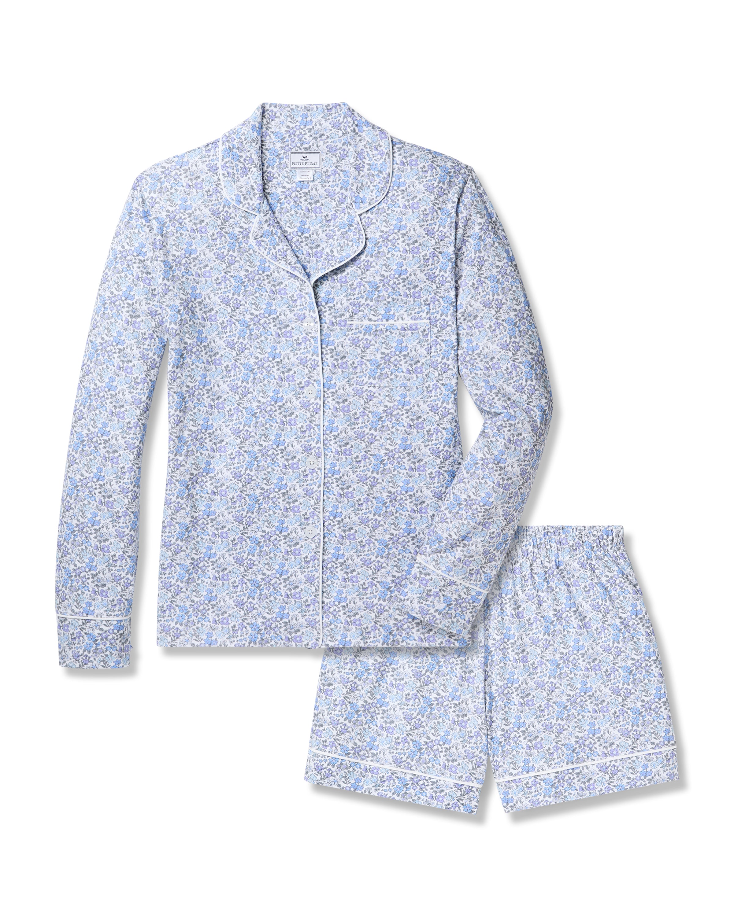 The Womens Pima Long Sleeve Short Set in Fleur dAzur by Petite Plume features a light blue floral-patterned design with a classic long-sleeve button-up shirt and mid-thigh shorts, enhanced by an intricate white floral motif for vintage charm.