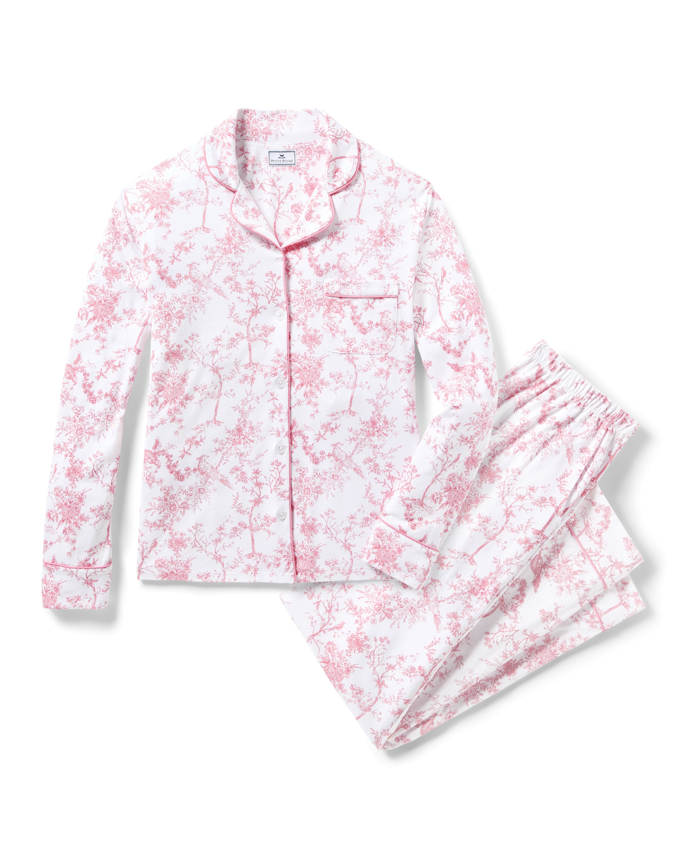 Discover the elegance of Petite Plumes Womens Pima Pajama in Pink Timeless Toile, a luxe jersey knit two-piece set. This ensemble, featuring a pink floral pattern on white, includes a long-sleeve button-up top with a chest pocket and matching elastic waistband pants—perfect for bedtime.