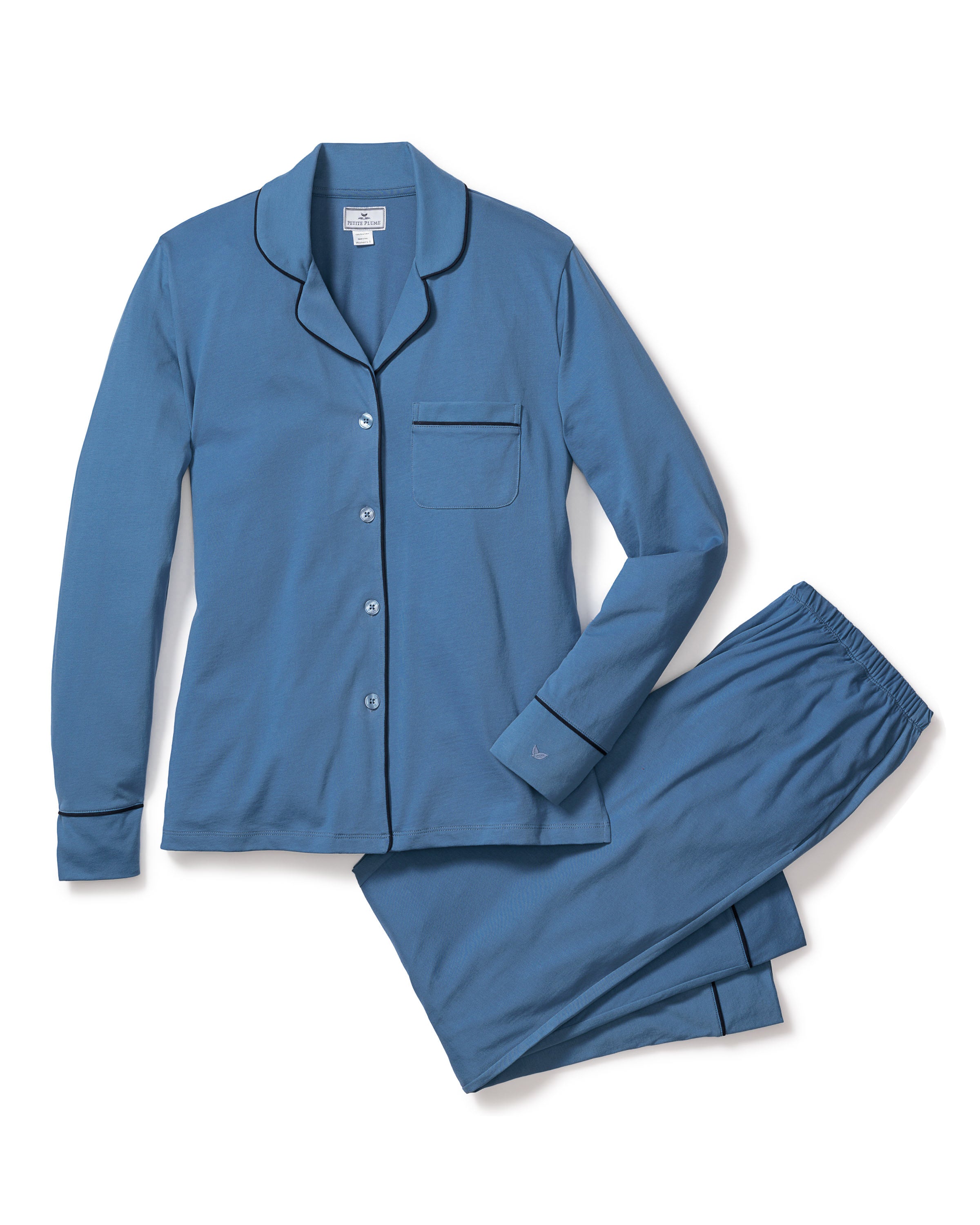 The Womens Pima Pajama Set in Mystique Blue by Petite Plume features a long-sleeve button-up top with a chest pocket and matching pants with an elastic waistband. Crafted from sumptuous Peruvian Pima cotton, it offers unparalleled softness and comfort for luxury sleepwear.