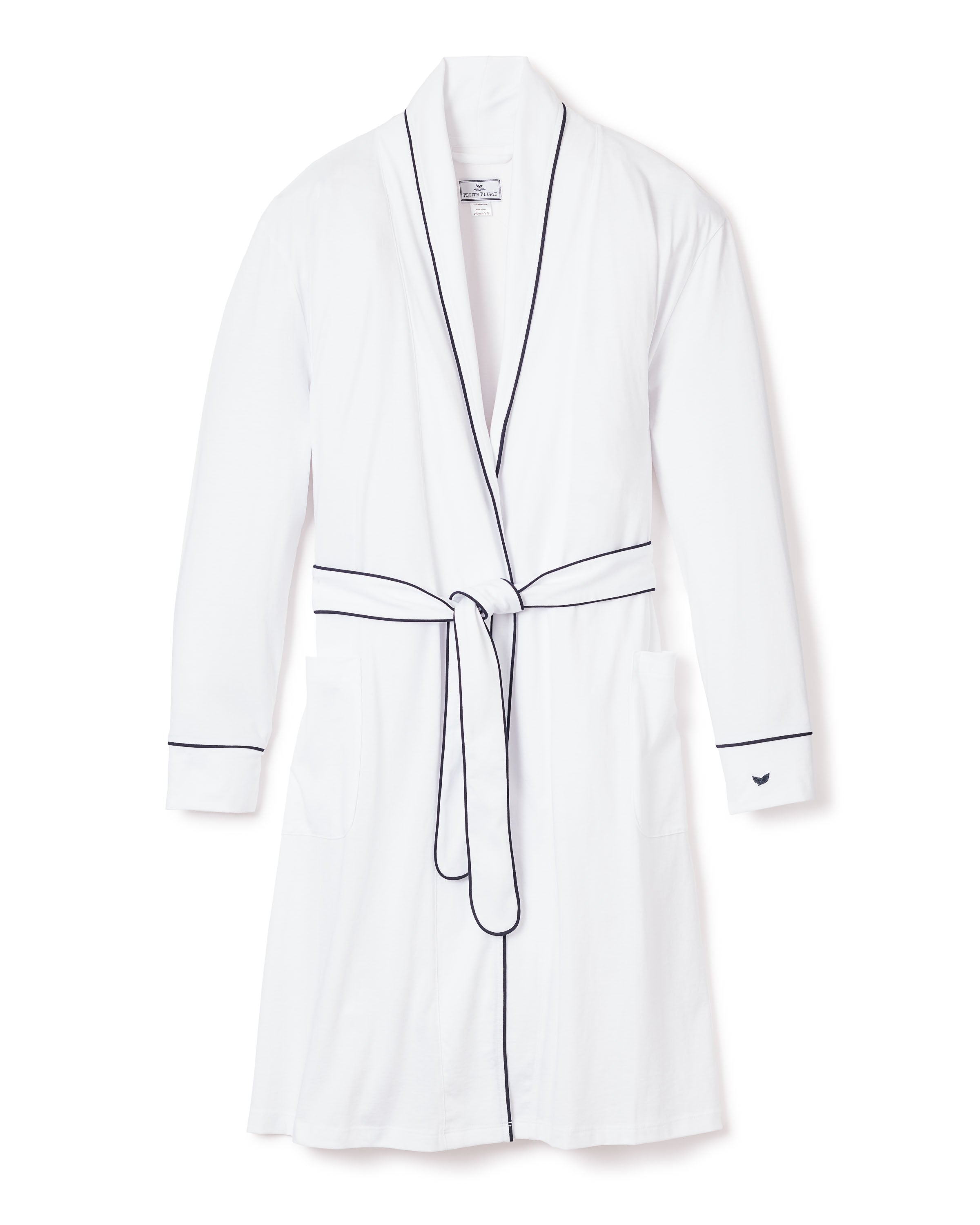 The Womens Pima Robe by Petite Plume, in white with navy piping, is a luxury Peruvian Pima cotton garment featuring two front pockets, a belt, and long sleeves. Its displayed against a white background.