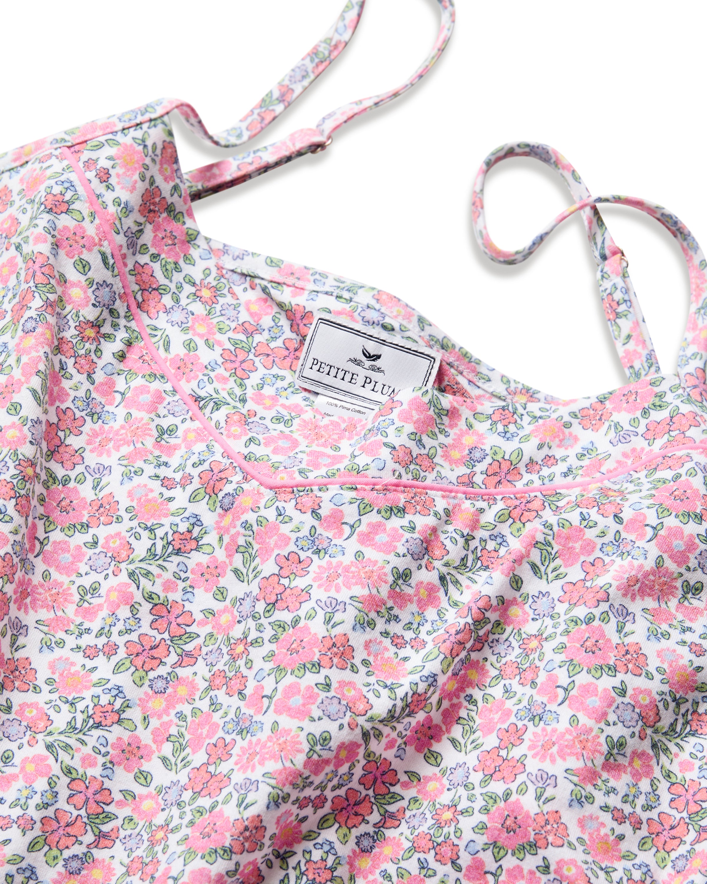 This exquisite pajama set from Petite Plume features the enchanting Fleurs de Rose print with pink and blue flowers, crafted in luxurious Pima cotton. The Womens Pima Sylvie Short Set showcases a close-up floral pattern and thin straps, adding a touch of elegance.