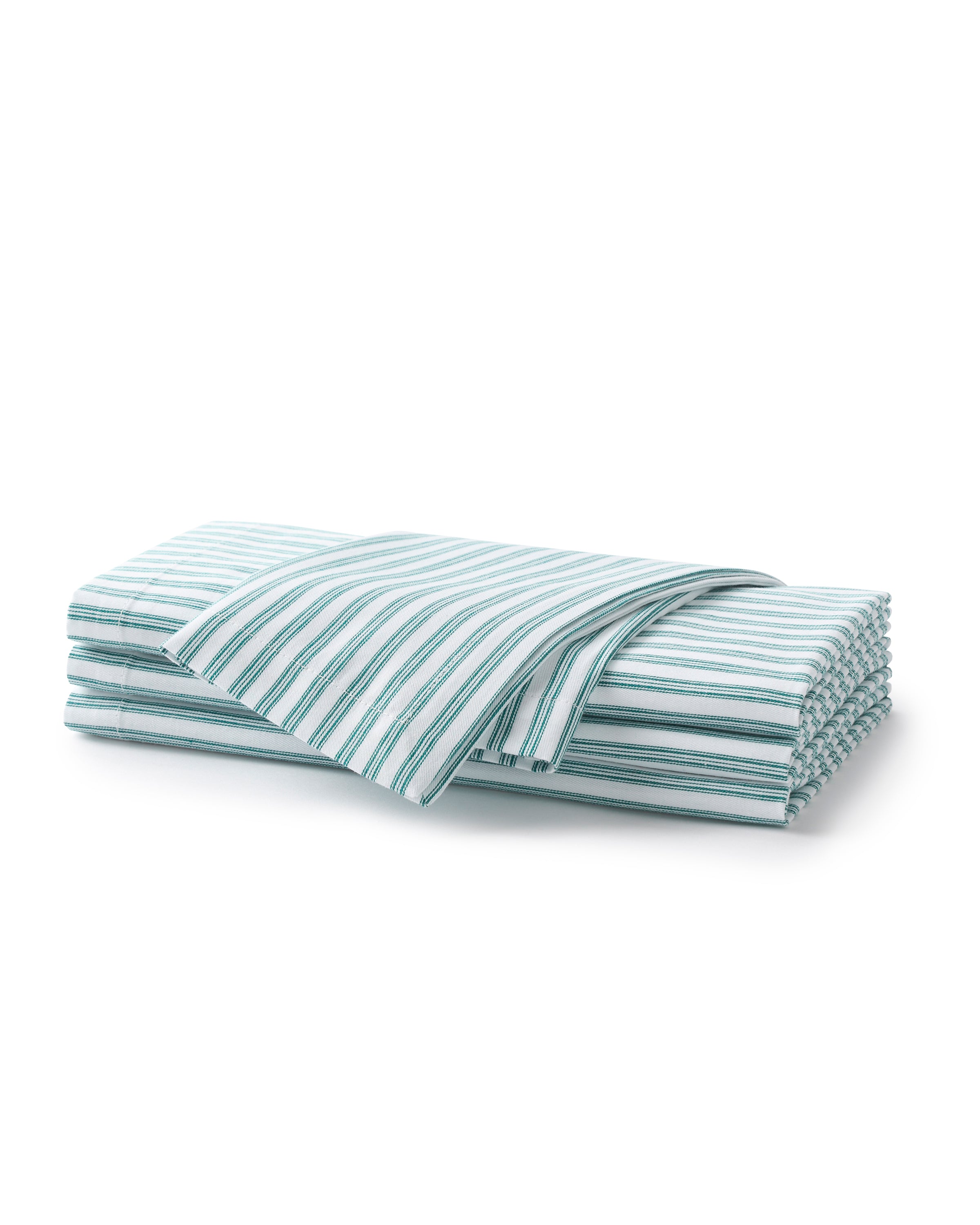 A neatly folded set of Signature Twill Napkins in Emerald Ticking by Petite Plume on a white background. Crafted from 100% cotton, one napkin is slightly unfolded, showcasing the pattern and evoking a freshness similar to crisp table linens ideal for a festive tablescape.