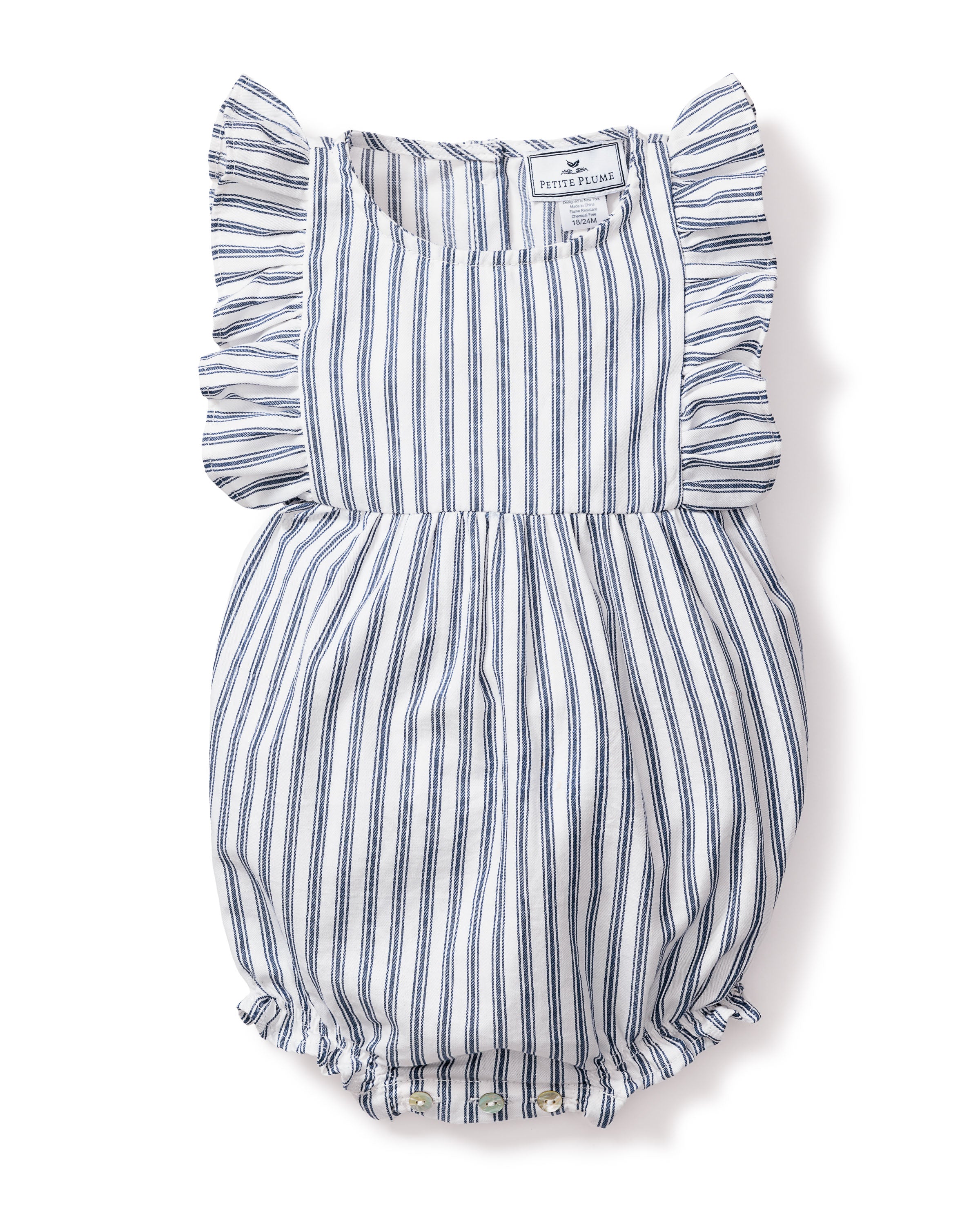 The Babys Twill Ruffled Rompers in Navy French Ticking by Petite Plume is a sleeveless romper made from yarn-dyed cotton with blue and white stripes. It features ruffled shoulders, elastic leg openings, and small bottom buttons for easy changes—ideal for cozy sleepwear or playful adventures.