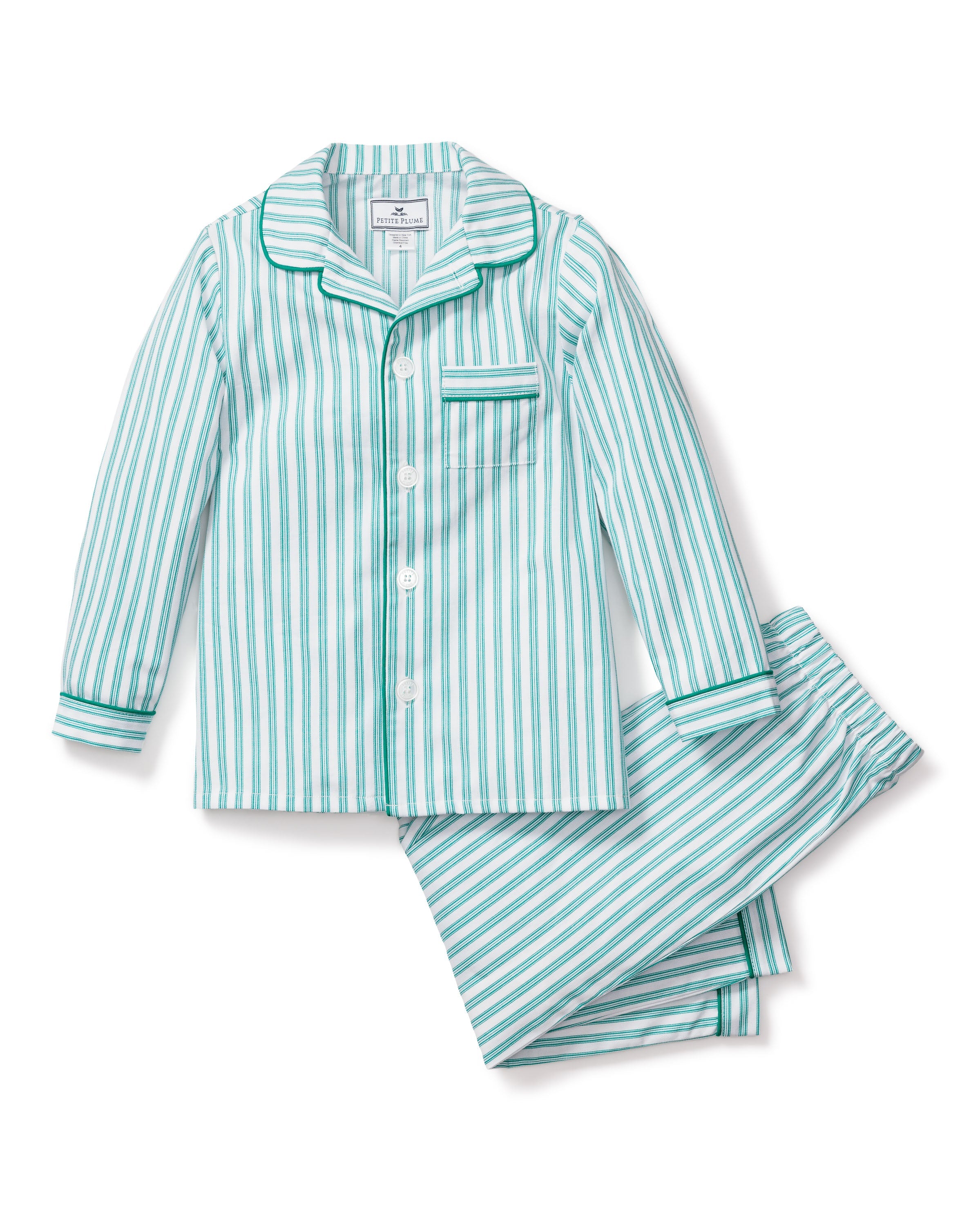 The Kids Twill Pajama Set in Emerald Ticking by Petite Plume features a long-sleeve button-up shirt with pocket and matching pants, showcasing vertical white and green stripes in a French ticking pattern, complete with piping details on the collar, cuffs, and pocket.