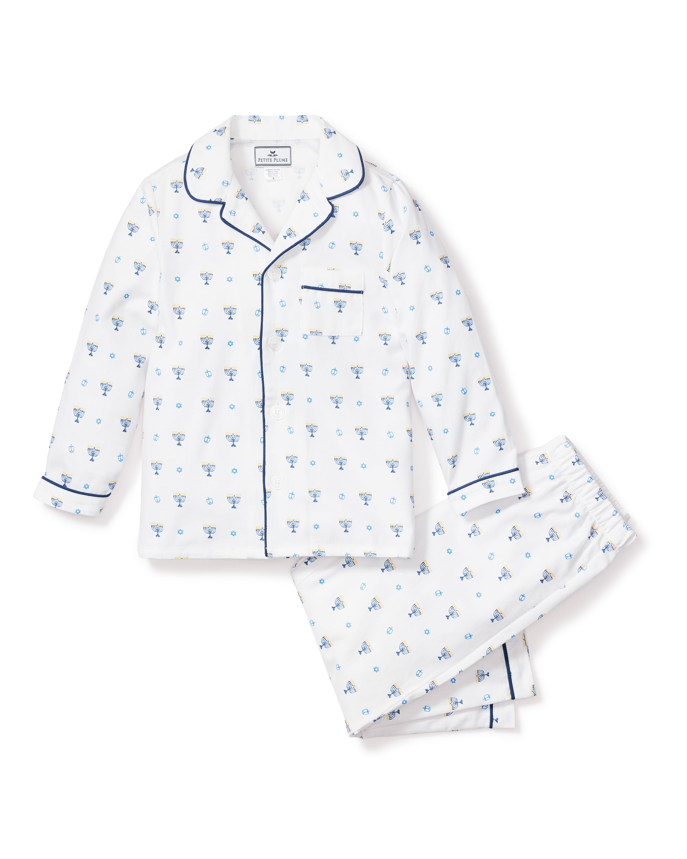 The Kids Twill Pajama Set in Happy Hanukkah by Petite Plume features a white two-piece set with blue piping, a small blue floral pattern, a long-sleeve button-up top with chest pocket, and matching elastic-waist pants, all made from moisture-wicking fabric for enhanced comfort.