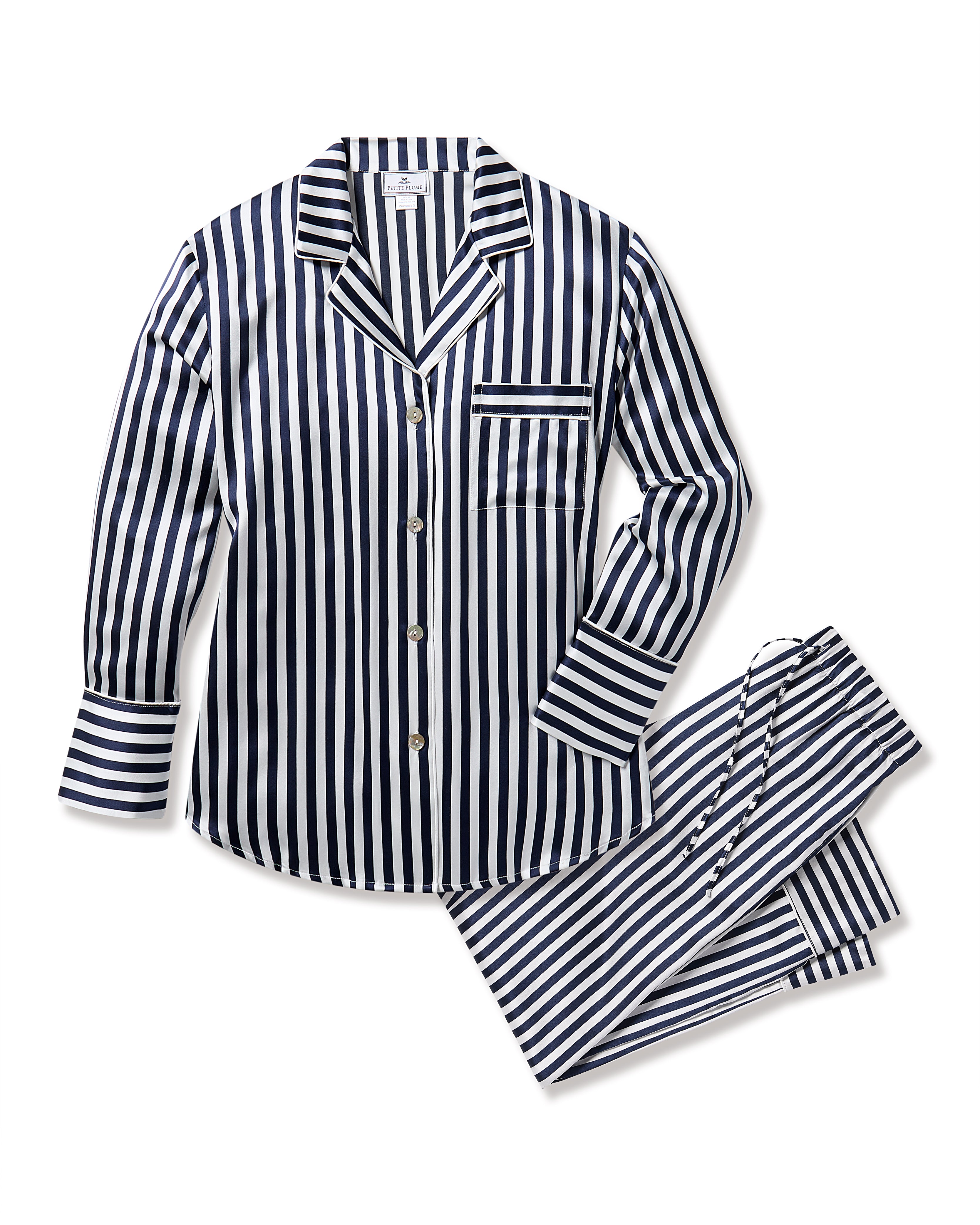 A luxury two-piece sleepwear set by Petite Plume in navy Bengal stripe, featuring a button-up long-sleeved silk shirt with a chest pocket and matching pants with an adjustable drawstring waistband.