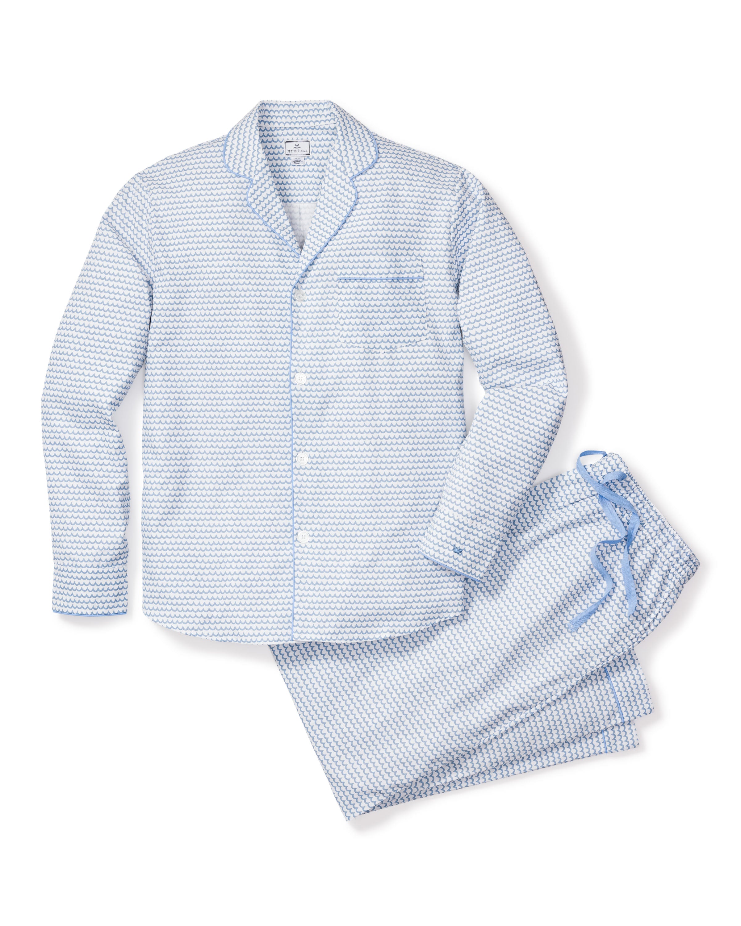 The Mens Twill Pajama Set in La Mer by Petite Plume features buttons, a collar, and drawstring pants. Crafted from top-quality cotton, it offers exceptional softness and comfort in a classic light blue and white design.