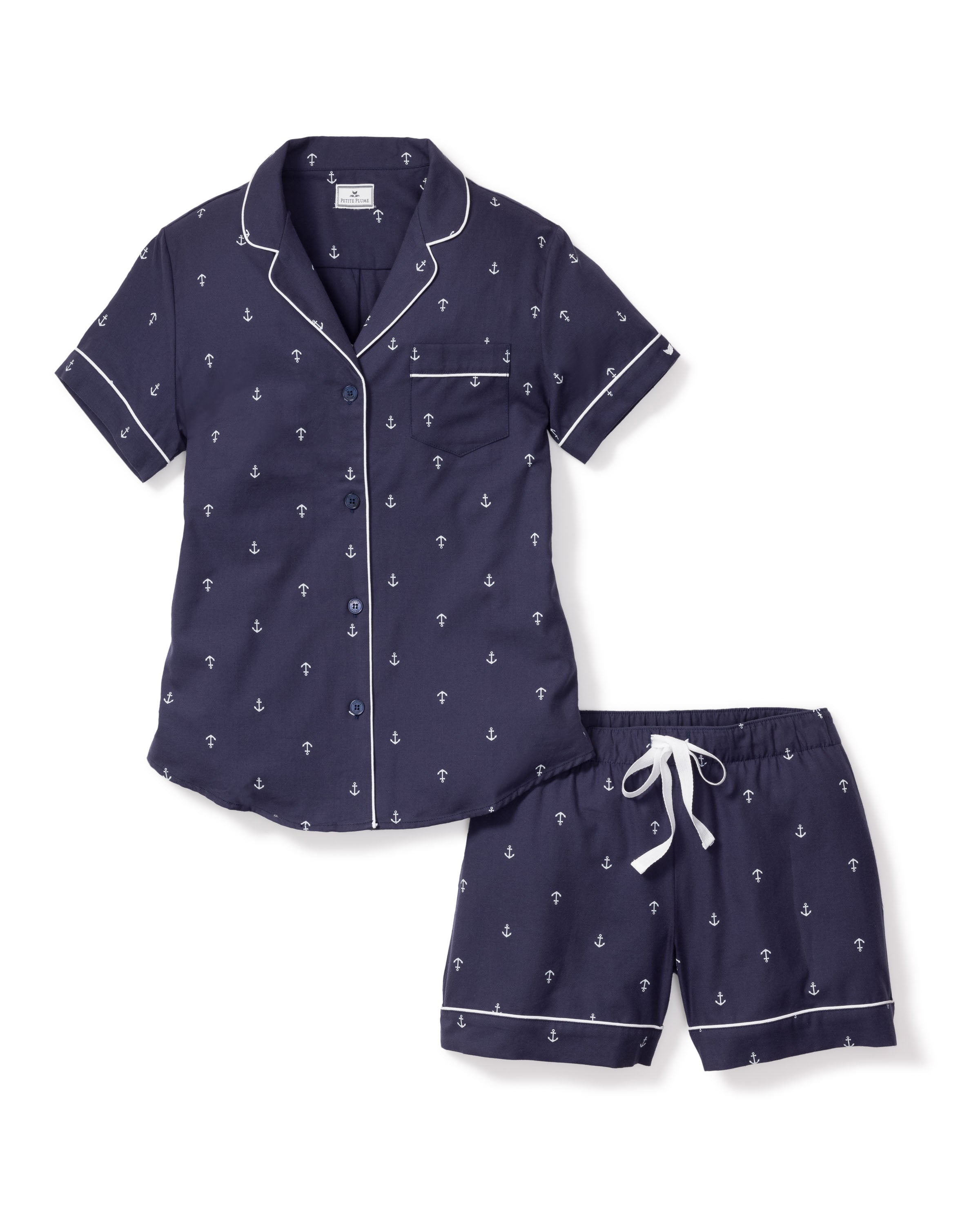 The Womens Twill Pajama Short Sleeve Short Set in Portsmouth Anchors by Petite Plume features a navy anchor print with white piped collar, button-down top, and chest pocket. Made from fine cotton, the shorts have an elastic waistband and white drawstring for comfort.