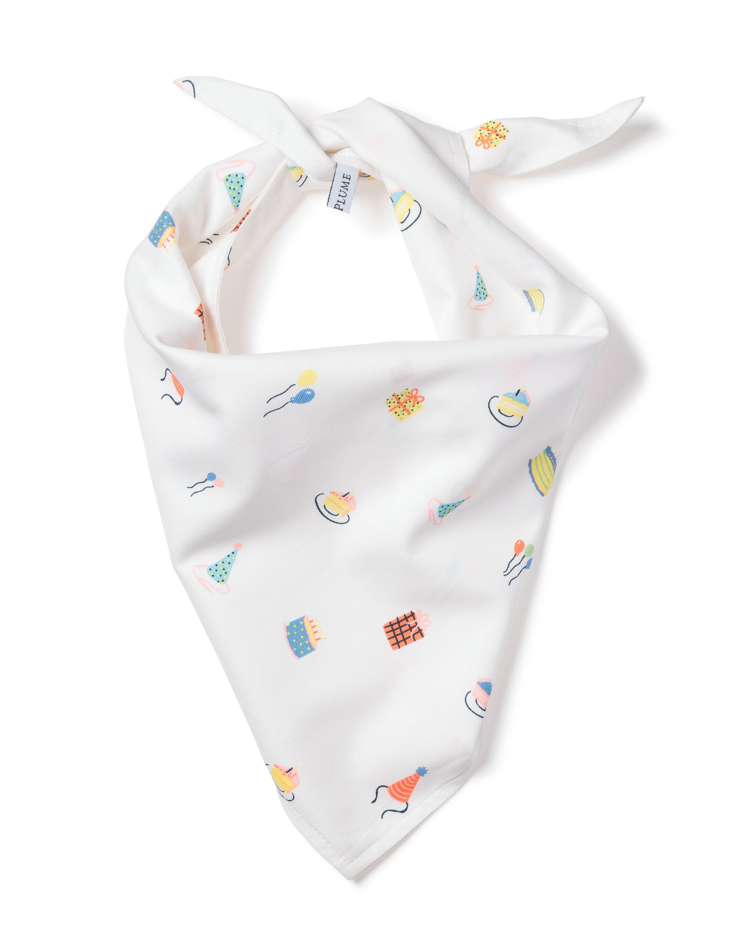 The Dog Twill Bandana in Birthday Wishes by Petite Plume features charming fabrics with colorful party-themed illustrations like cakes, balloons, and hats, tied at the top.