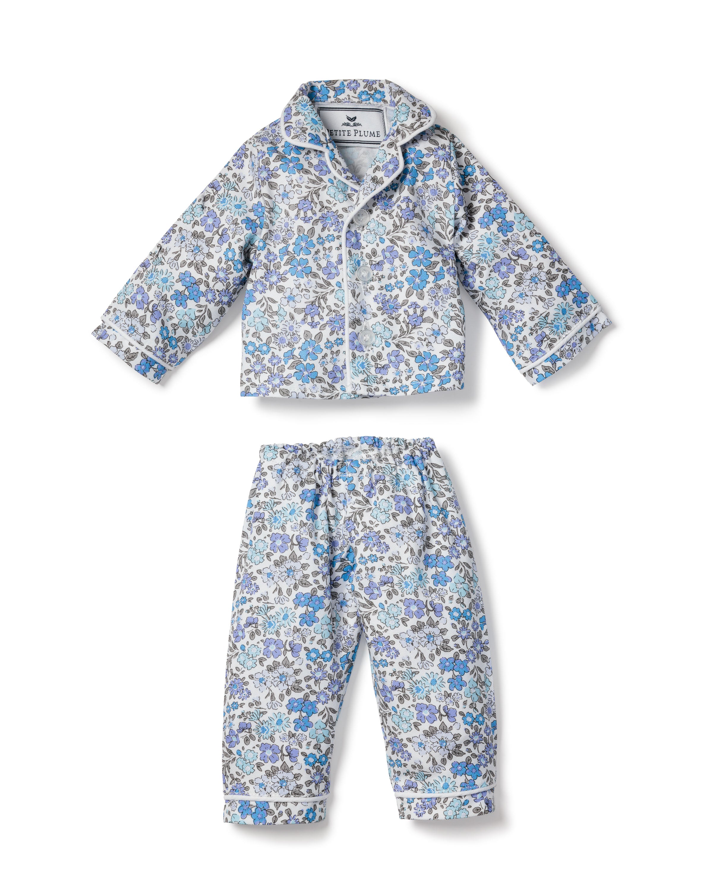 Petite Plumes Kids Twill Doll Pajamas Fleur DAzur features a floral-patterned long-sleeve top with a collar and button-down front, pants with an elastic waistband, perfect for matching sets with 18 dolls.