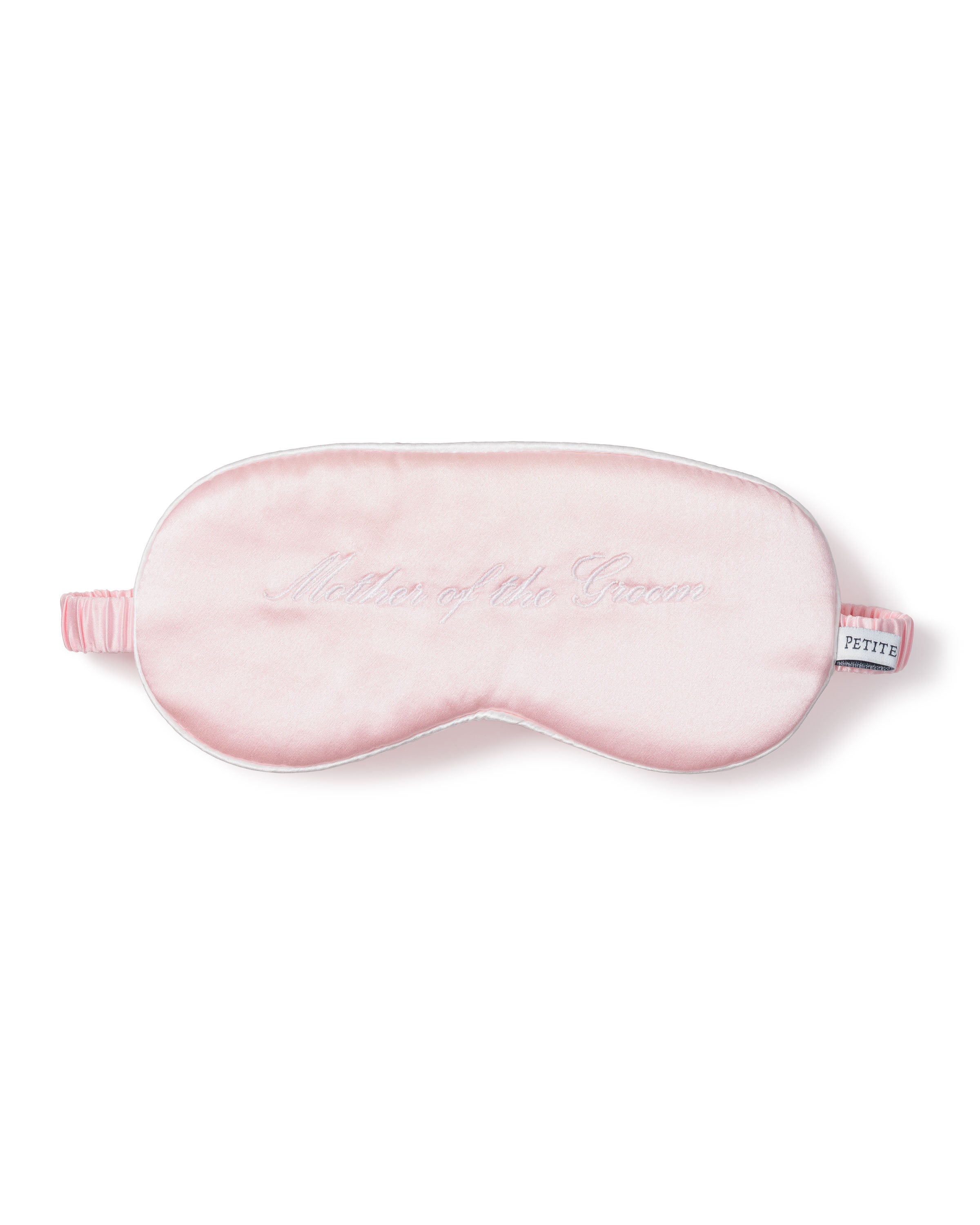 The Womens Silk Mother of the Groom Sleep Mask by Petite Plume is crafted from soft, pink 22mm pure silk. It features elegant embroidered script, an elastic strap for a snug fit, and a PETITE label, making it a perfect wedding day gift.