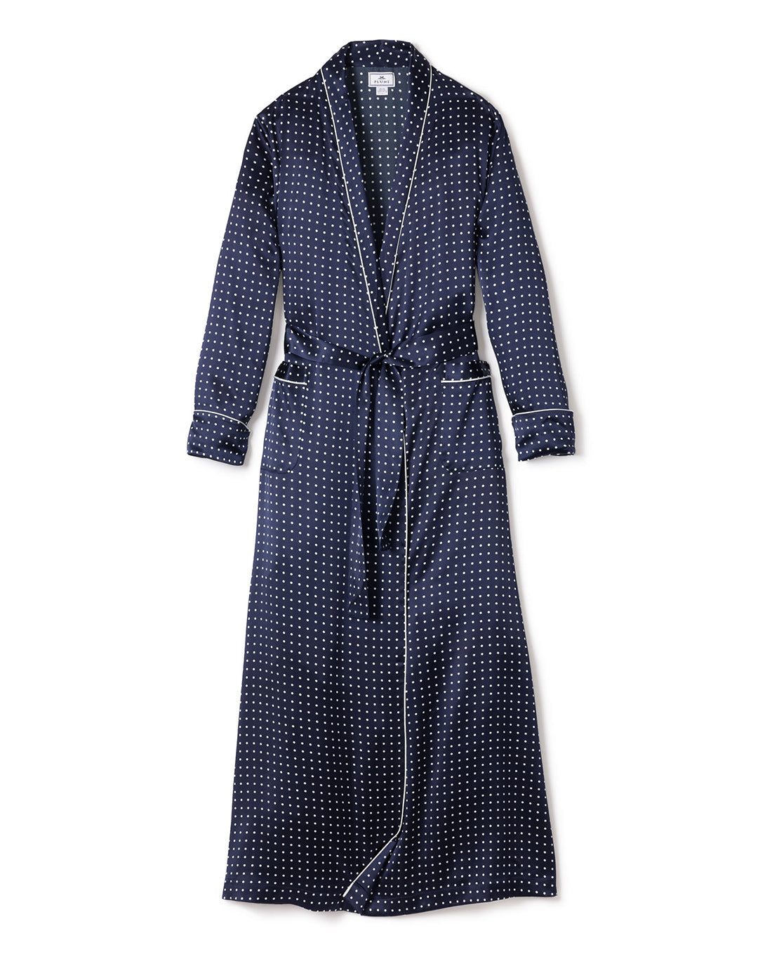 The Womens Silk Long Robe in Navy Polka Dot by Petite Plume features a luxurious shawl collar, waist belt, and elegant white piping on edges and cuffs. Its charming navy color with white polka dots makes it incredibly soft and comfortable luxury sleepwear.