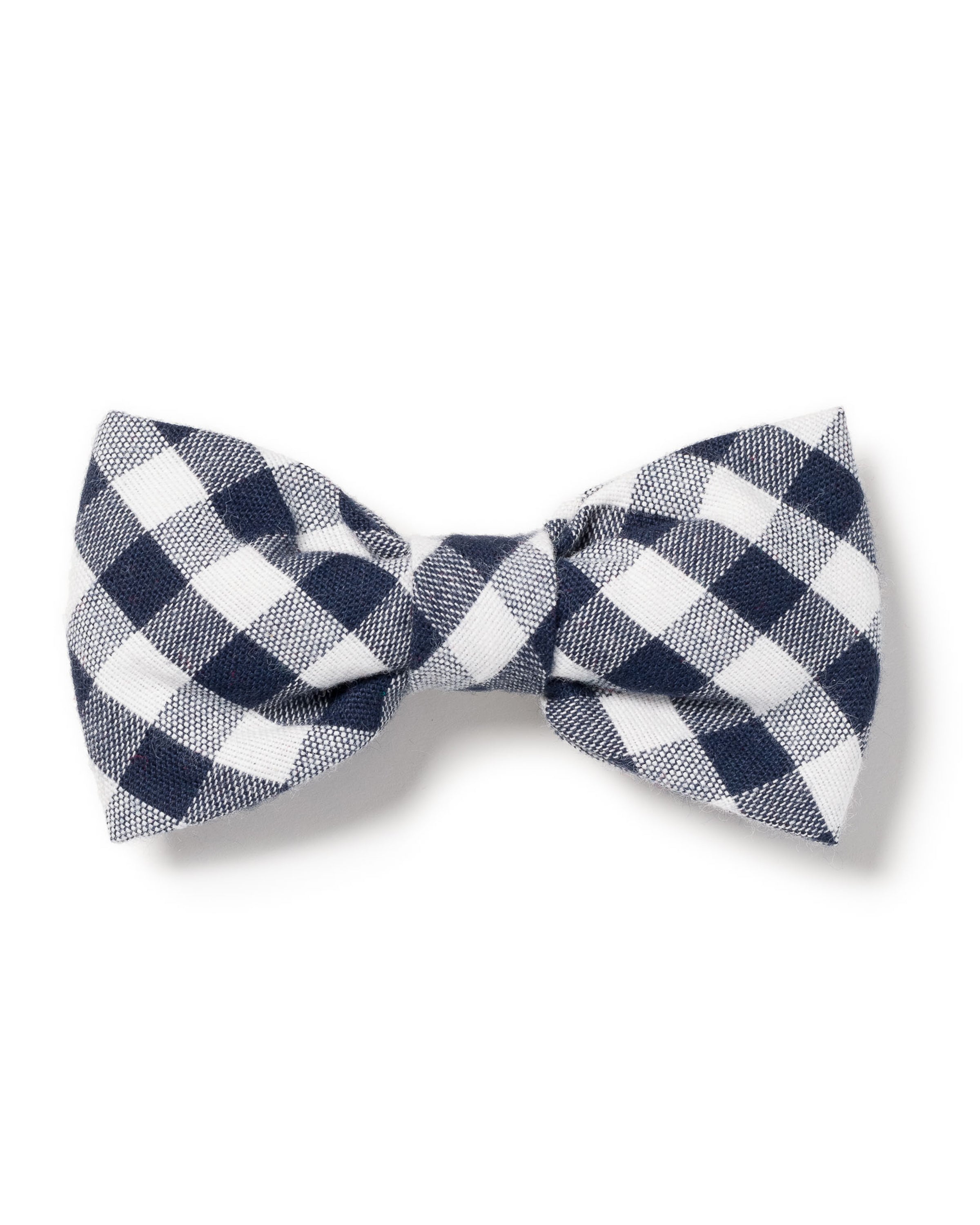 The Petite Plume Dog Bow Tie in Navy Gingham is showcased on a white background. This charming checkered fabric, neatly tied, enhances your pets style with its classic gingham pattern.