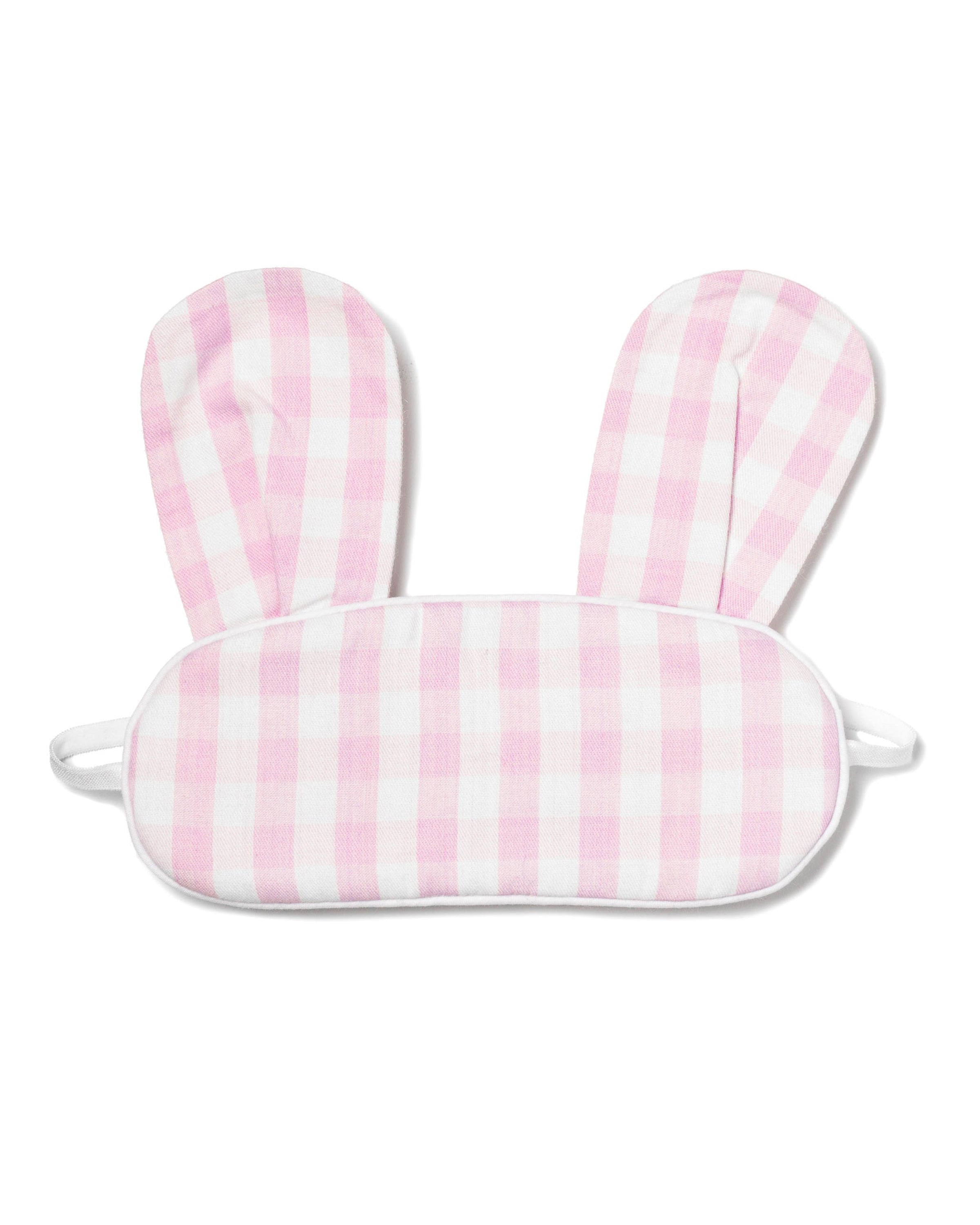 The Kids Twill Bunny Sleep Mask in Pink Gingham by Petite Plume features pink and white checkered fabric with bunny ears. It includes elastic straps for a snug fit, making it perfect for drifting into dreamland.