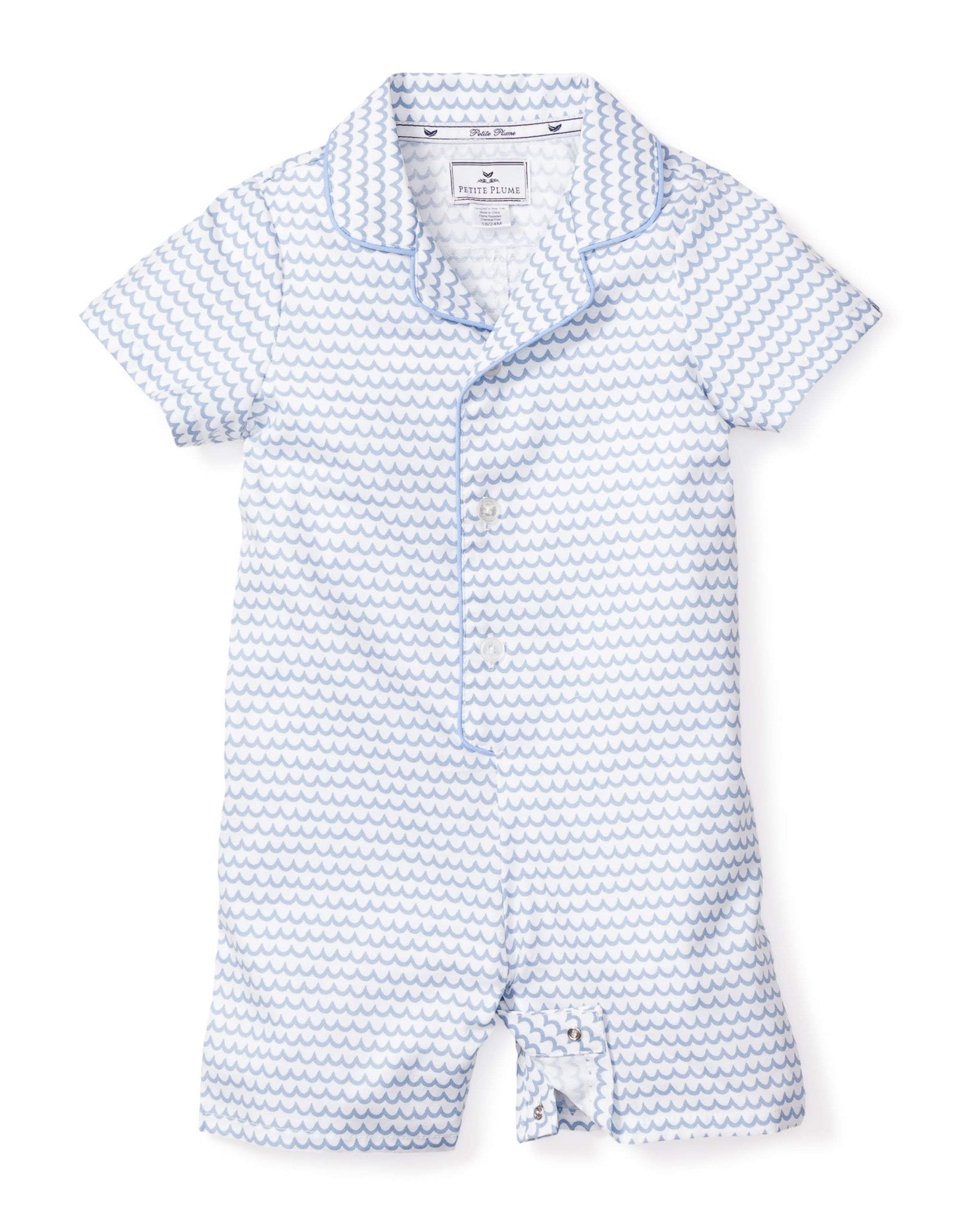 The Petite Plume Babys Twill Summer Romper in La Mer is made from brushed twill with a white and light blue wavy pattern. It features short sleeves, a collar, front buttons, and bottom snaps for easy changing.